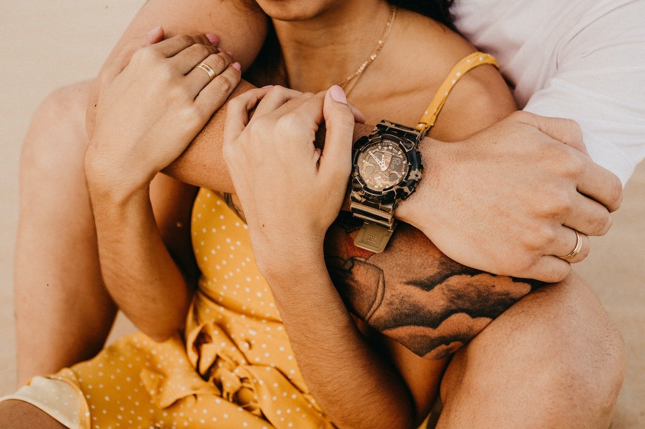 Man embracing woman