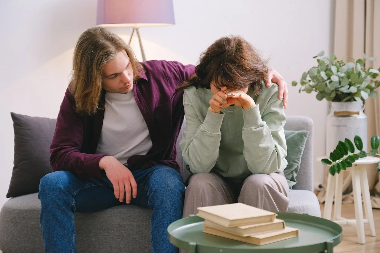 Man giving sad woman emotional support
