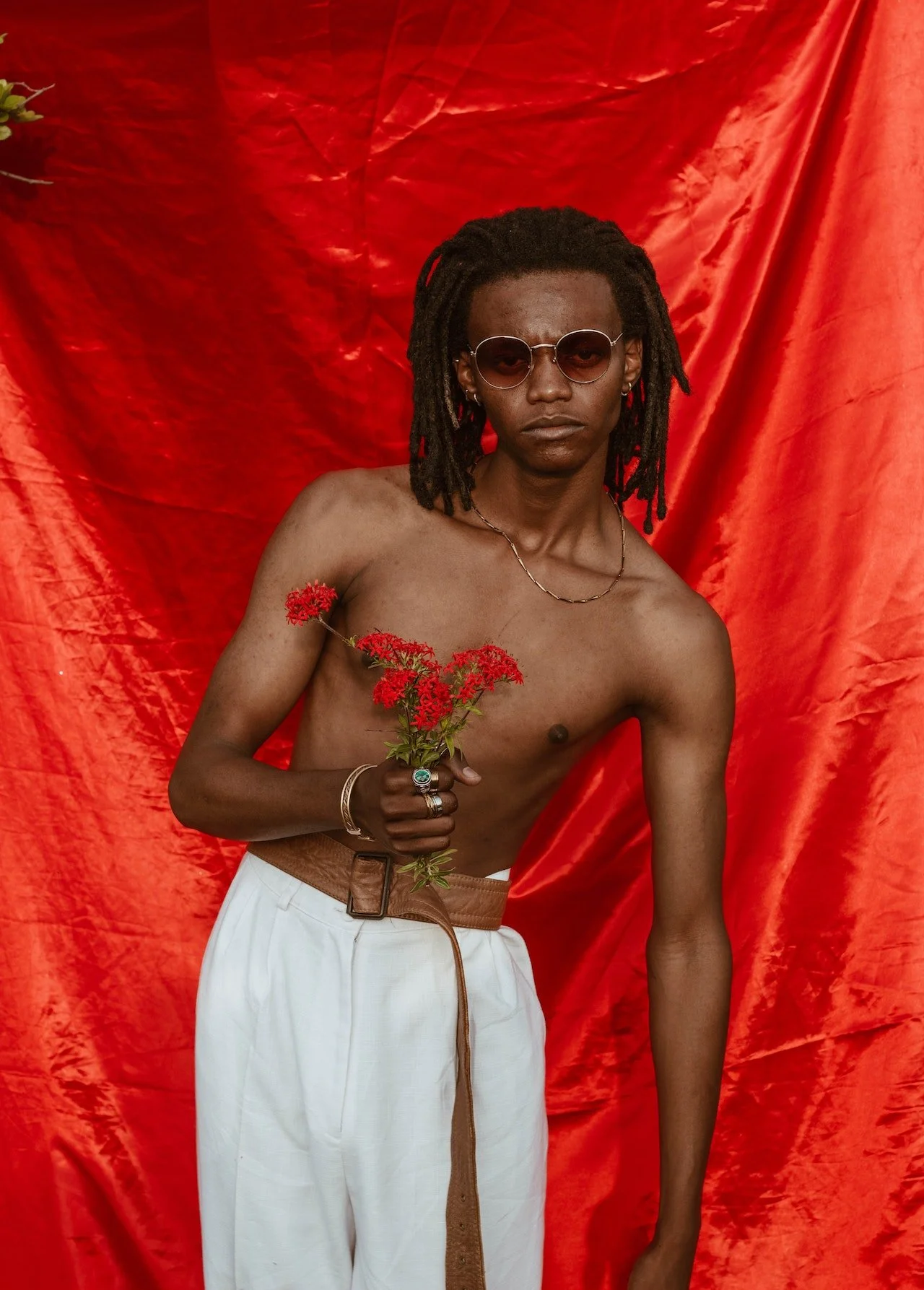 man holding red flowers