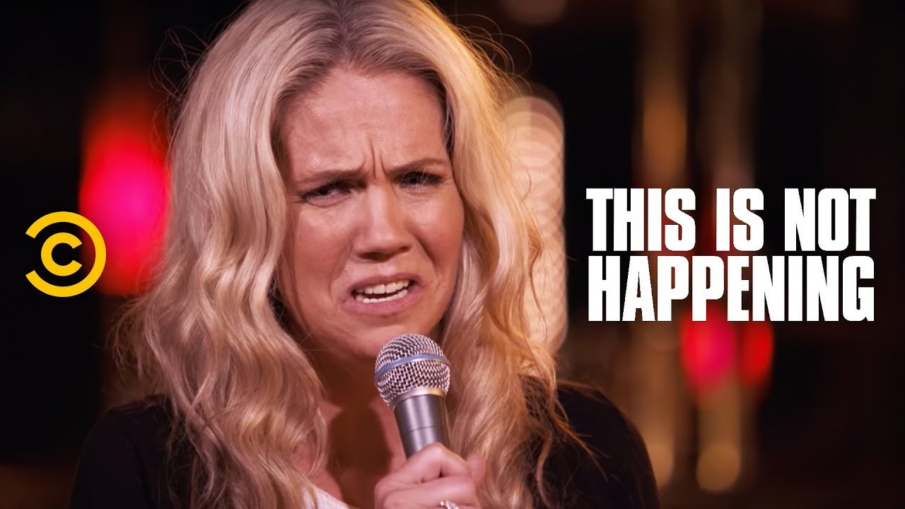 Jessa Reed holding a mic while performing stand up comedy
