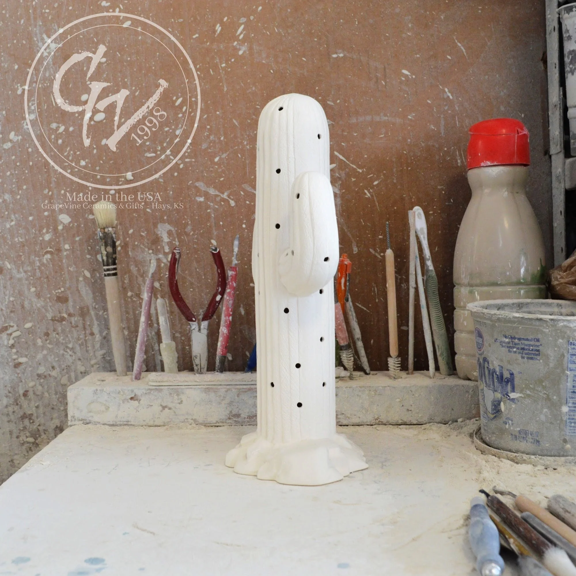 Unpainted white ceramic bisque Saguaro Cactus figurine with holes for Christmas lights, 11 inches tall.