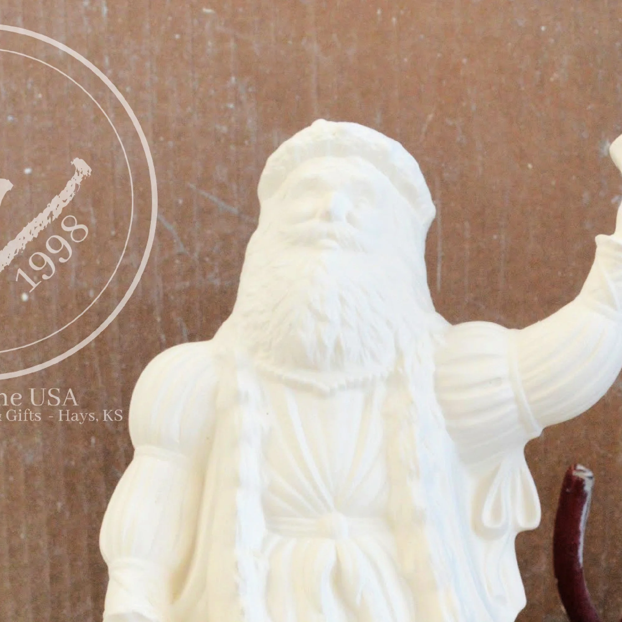 Close-up of the detailed facial features and beard on a ready-to-paint ceramic Father Christmas.