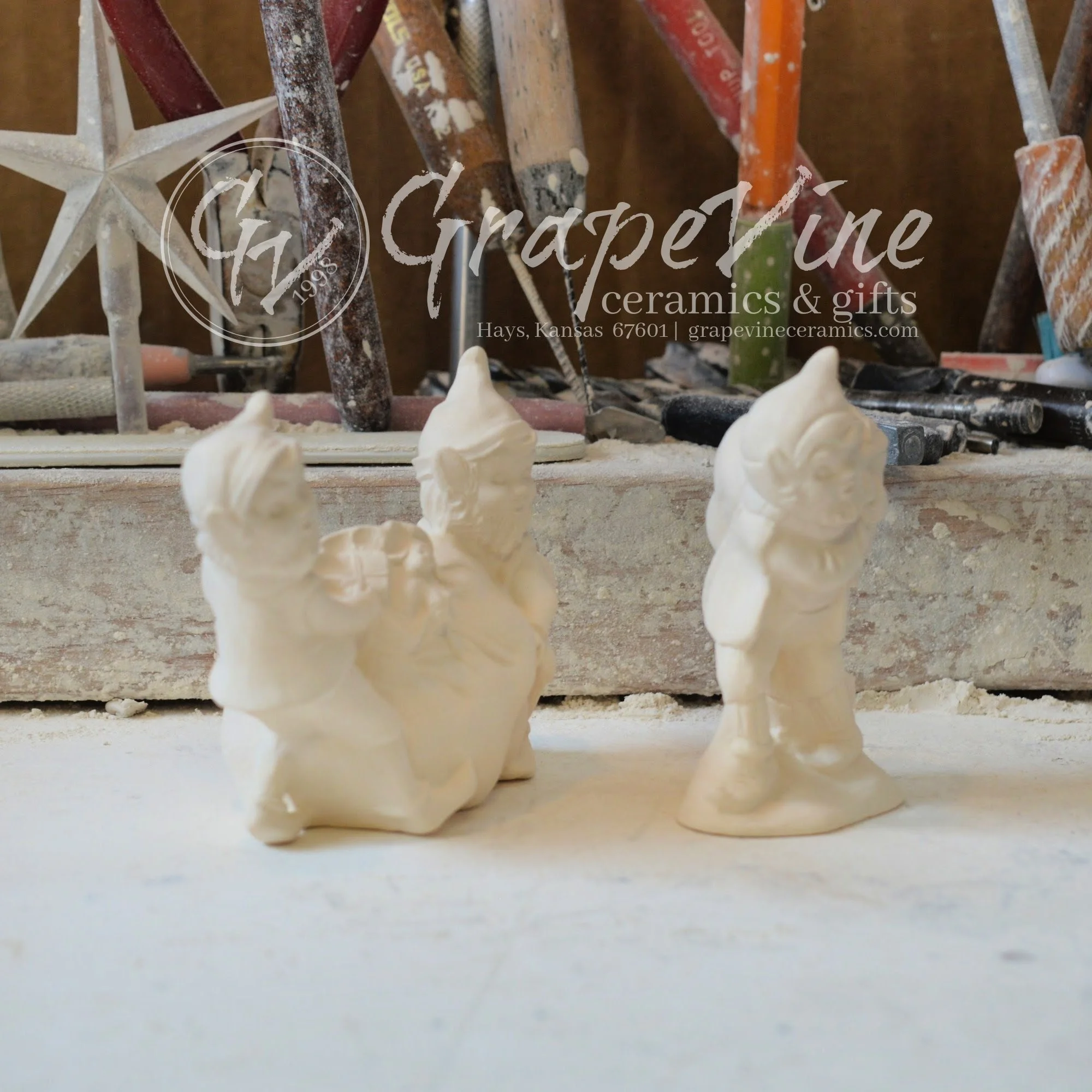 Side view of ceramic elf figurines with toy bag