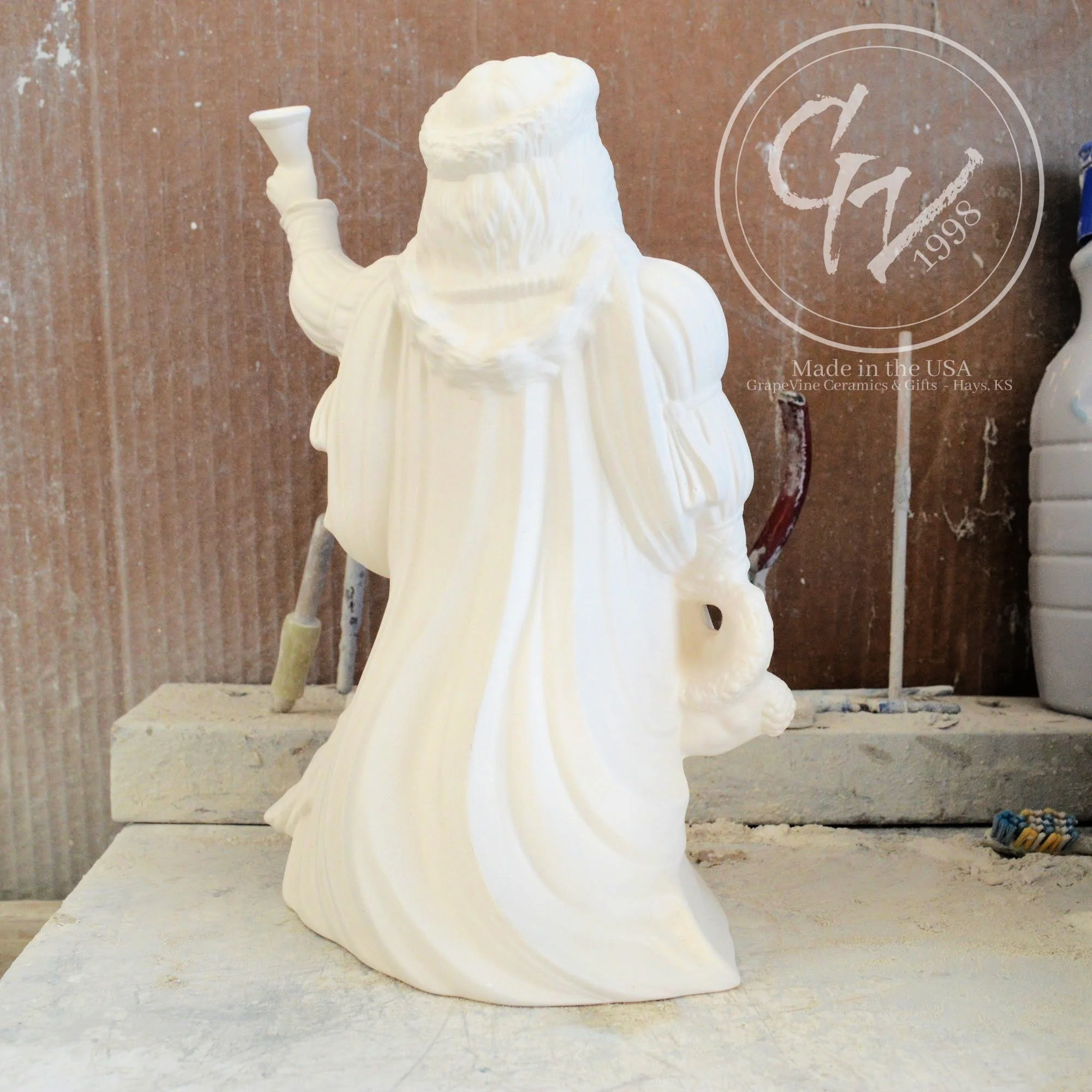 Rear view of the Old English Santa bisque showing the flowing textures of the traditional hooded cloak.