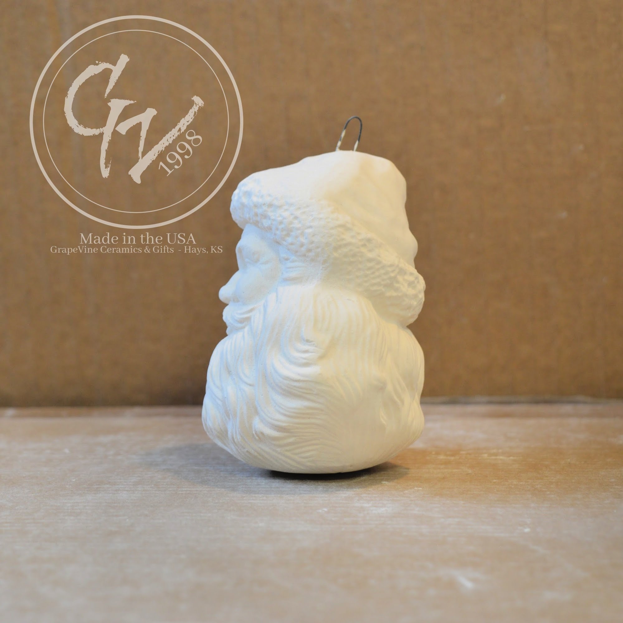 Side view Hand-poured Santa Head ceramic ornament ready to paint