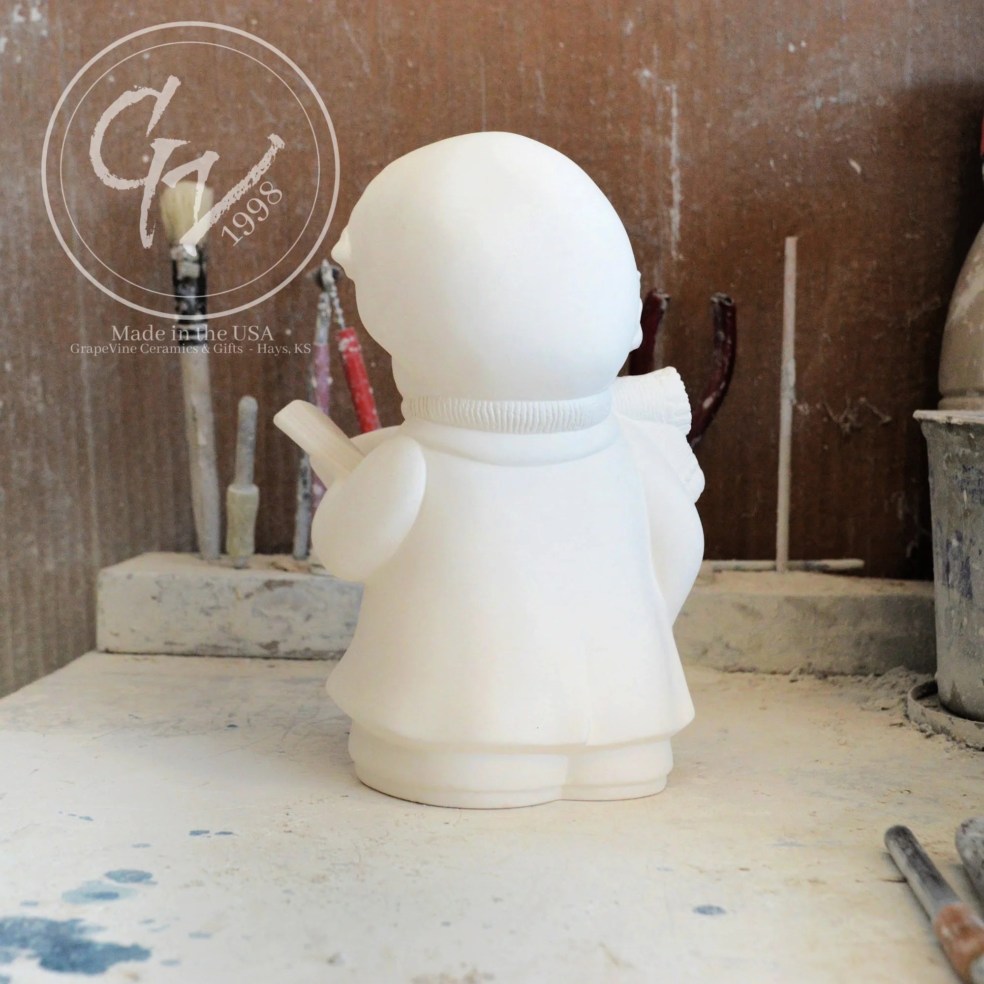 Rear angle profile of the ceramic Christmas bear showing clean mold lines and high-quality bisque finish.