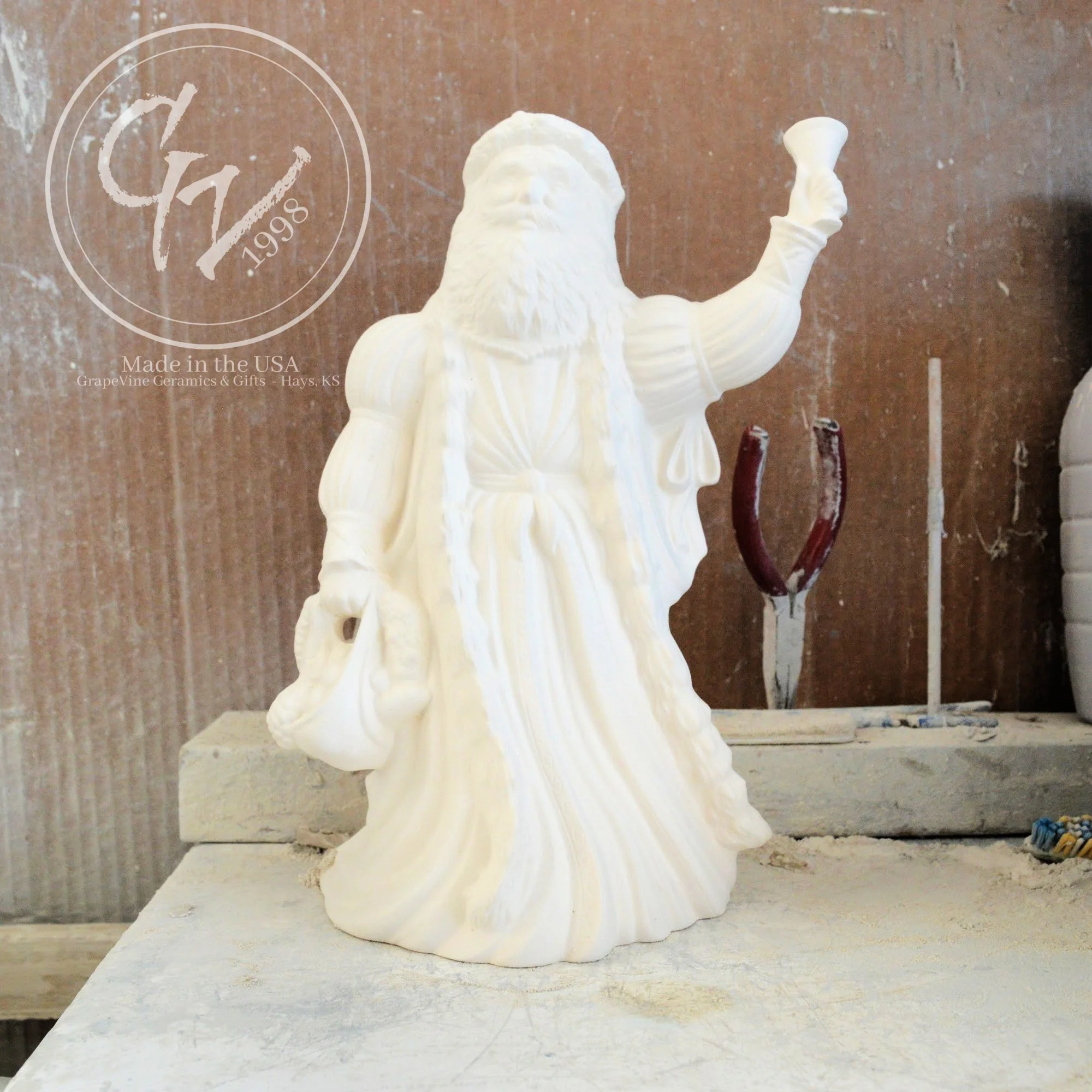10-inch unpainted Old English Santa ceramic bisque figurine with hooded robe and staff.