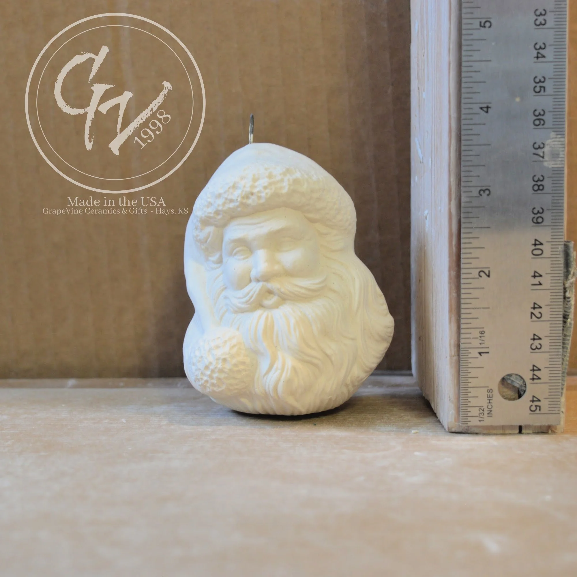 Hand-poured Santa Head ceramic ornament ready to paint with ruler for scale