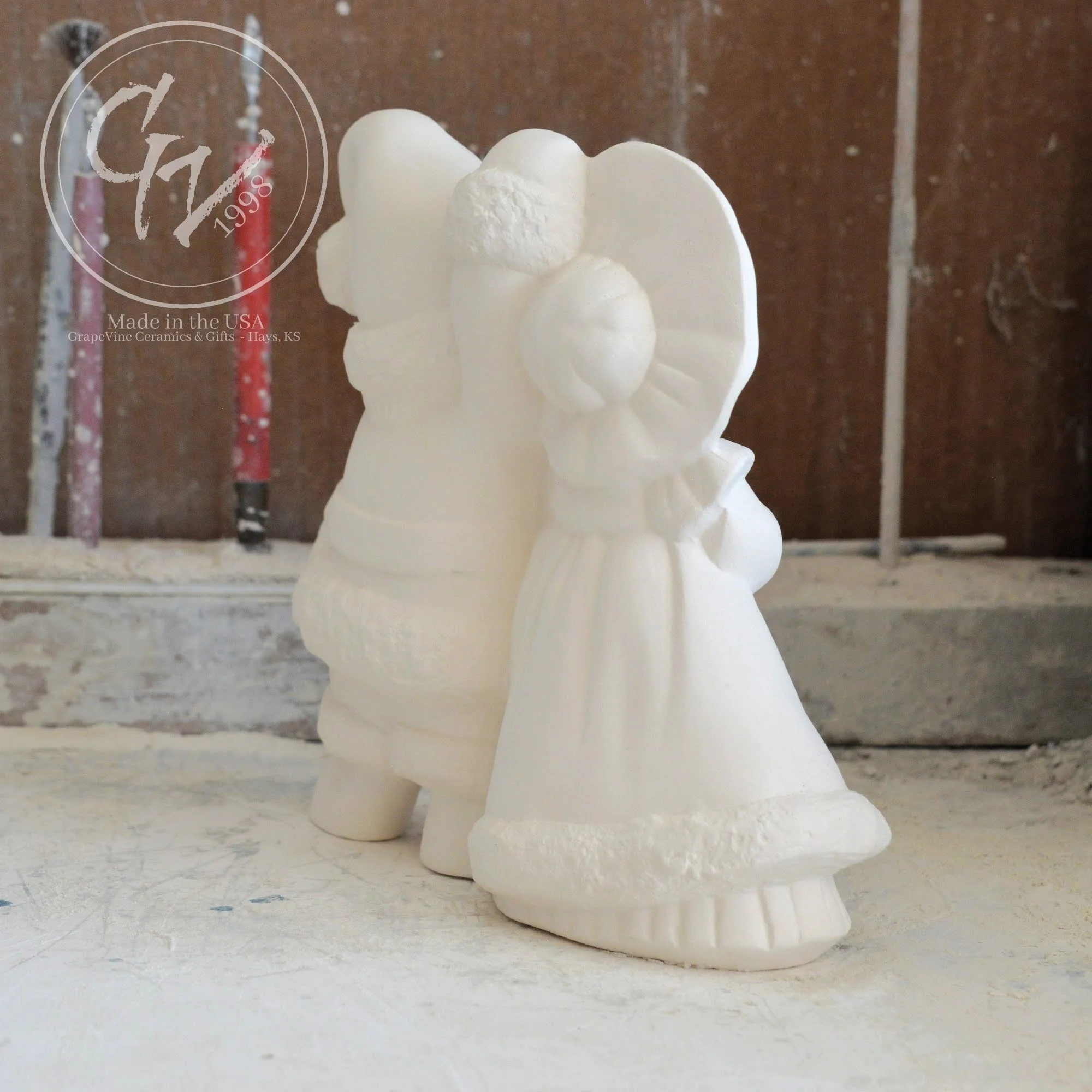 Side profile of smooth, professionally cleaned white ceramic Santa figurines ready for acrylic paint or kiln glazing.