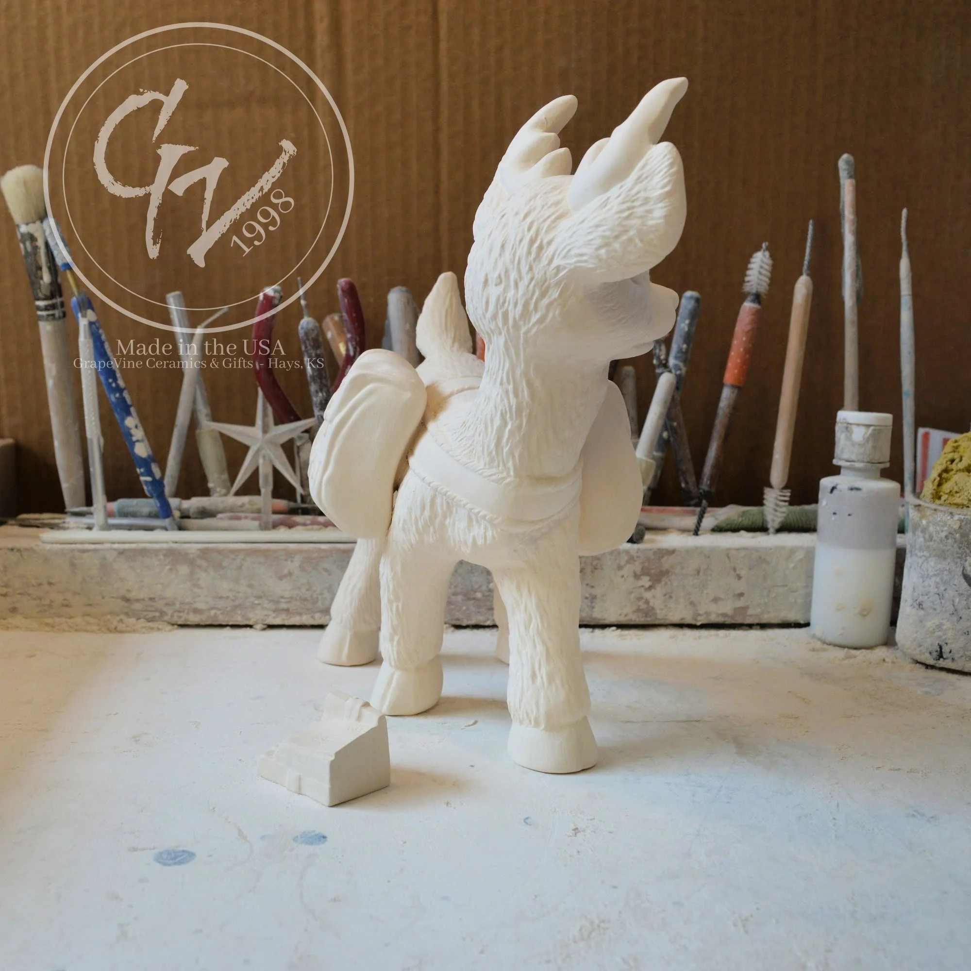 Side view of ready‑to‑paint reindeer carrying holiday mailbag