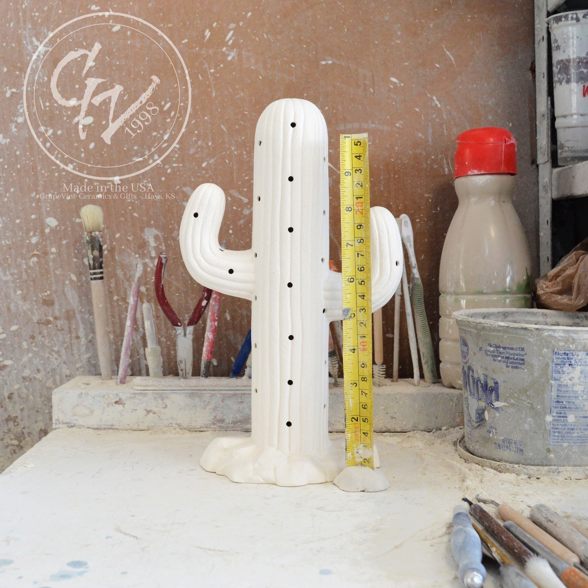 Unpainted white ceramic bisque Saguaro Cactus figurine with holes for Christmas lights, 11 inches tall.