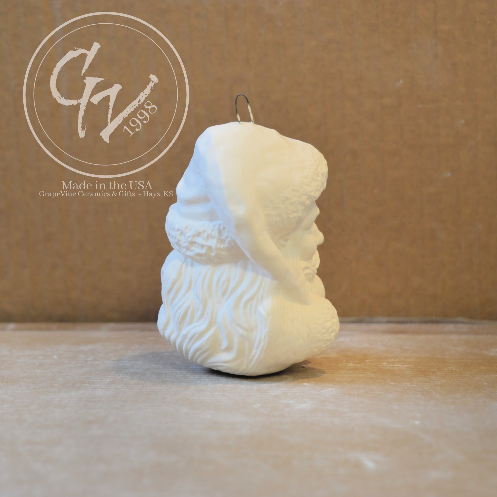 Side view Hand-poured Santa Head ceramic ornament ready to paint