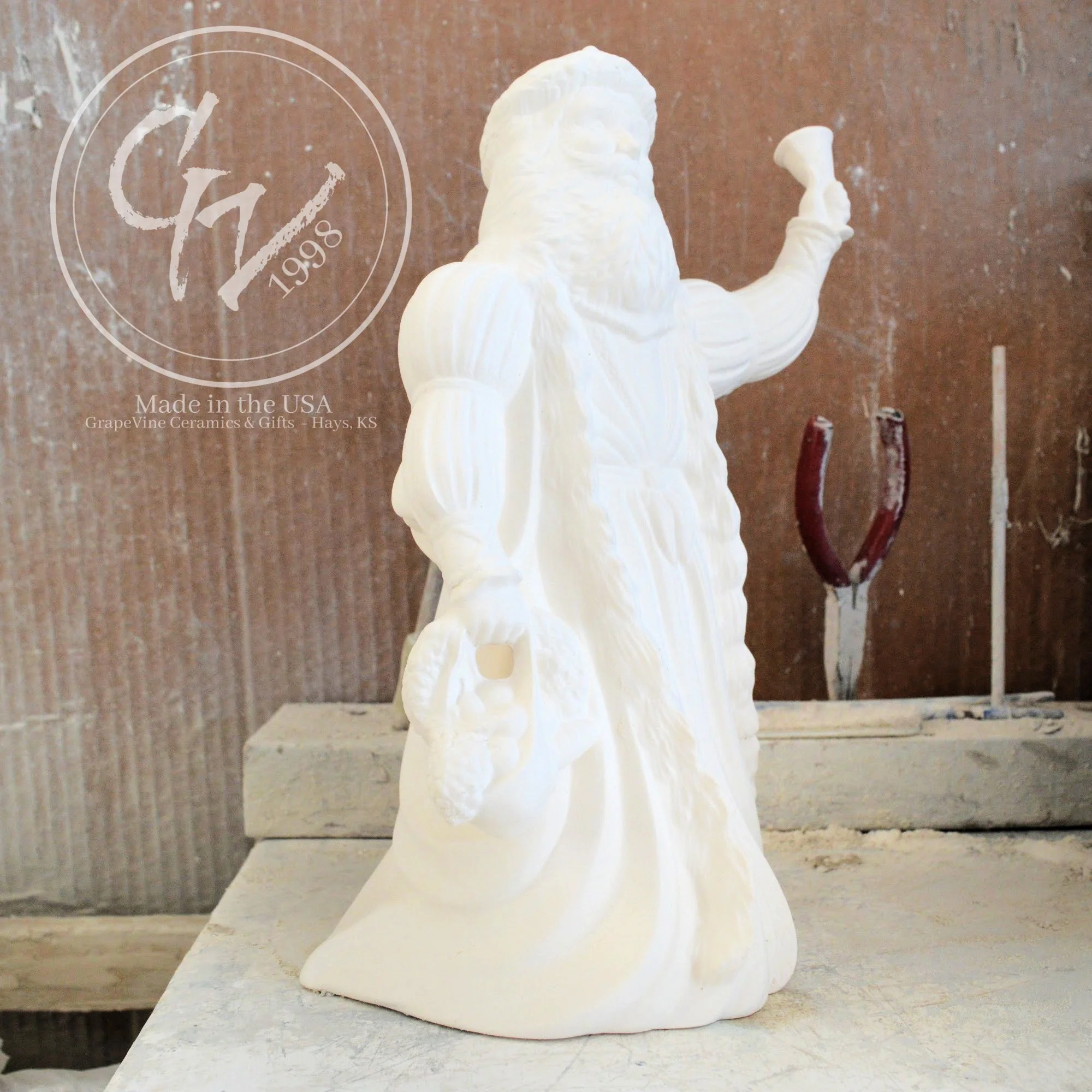 Side view of the Old English Santa bisque showing the flowing textures of the traditional hooded cloak.