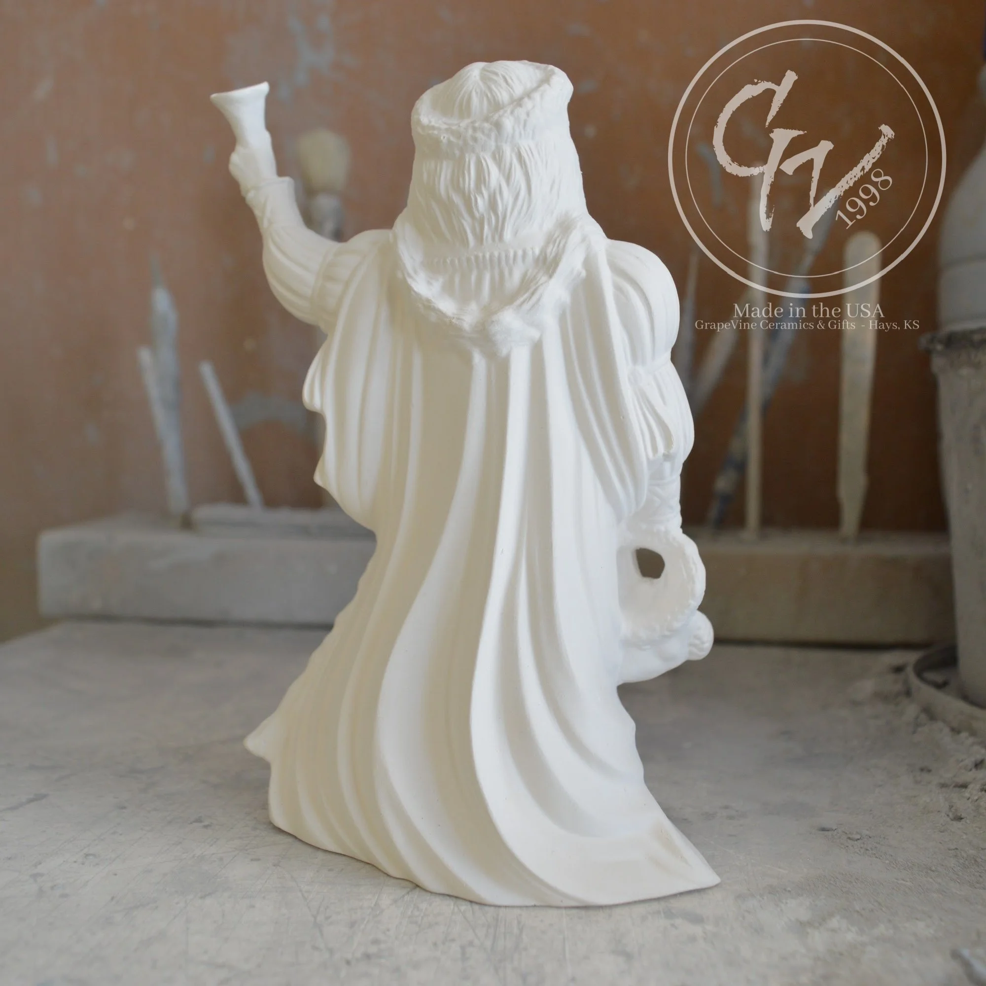Rear view Small unpainted English Santa ceramic bisque figurine, 6 inches tall, featuring a traditional long robe and staff.