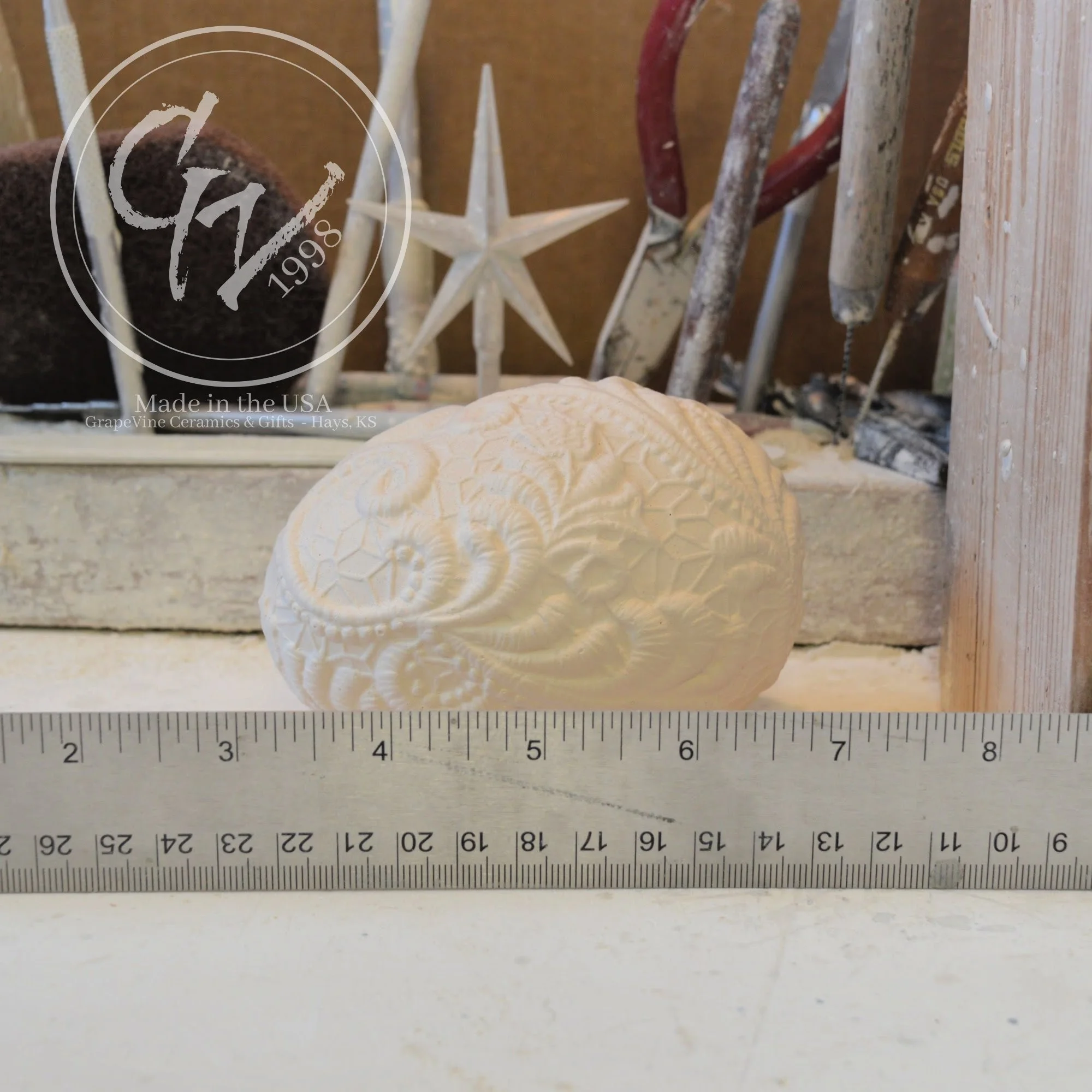Resting lace duck egg ceramic bisque shown for size comparison and seasonal decorating