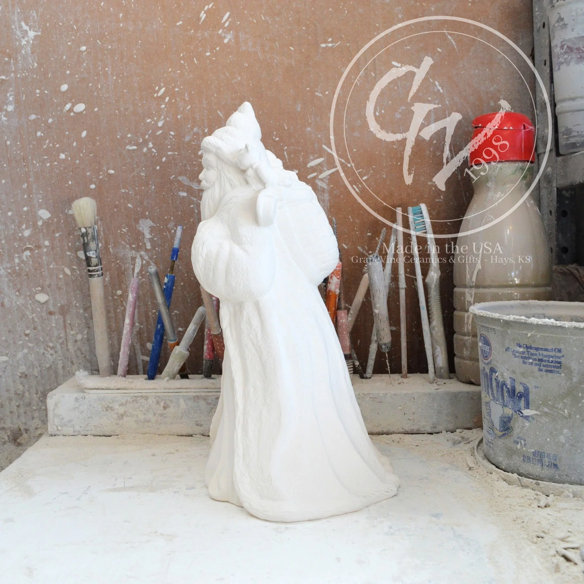 Elegant side profile of the rare French Santa bisque showing its unique slim silhouette and flowing robe.