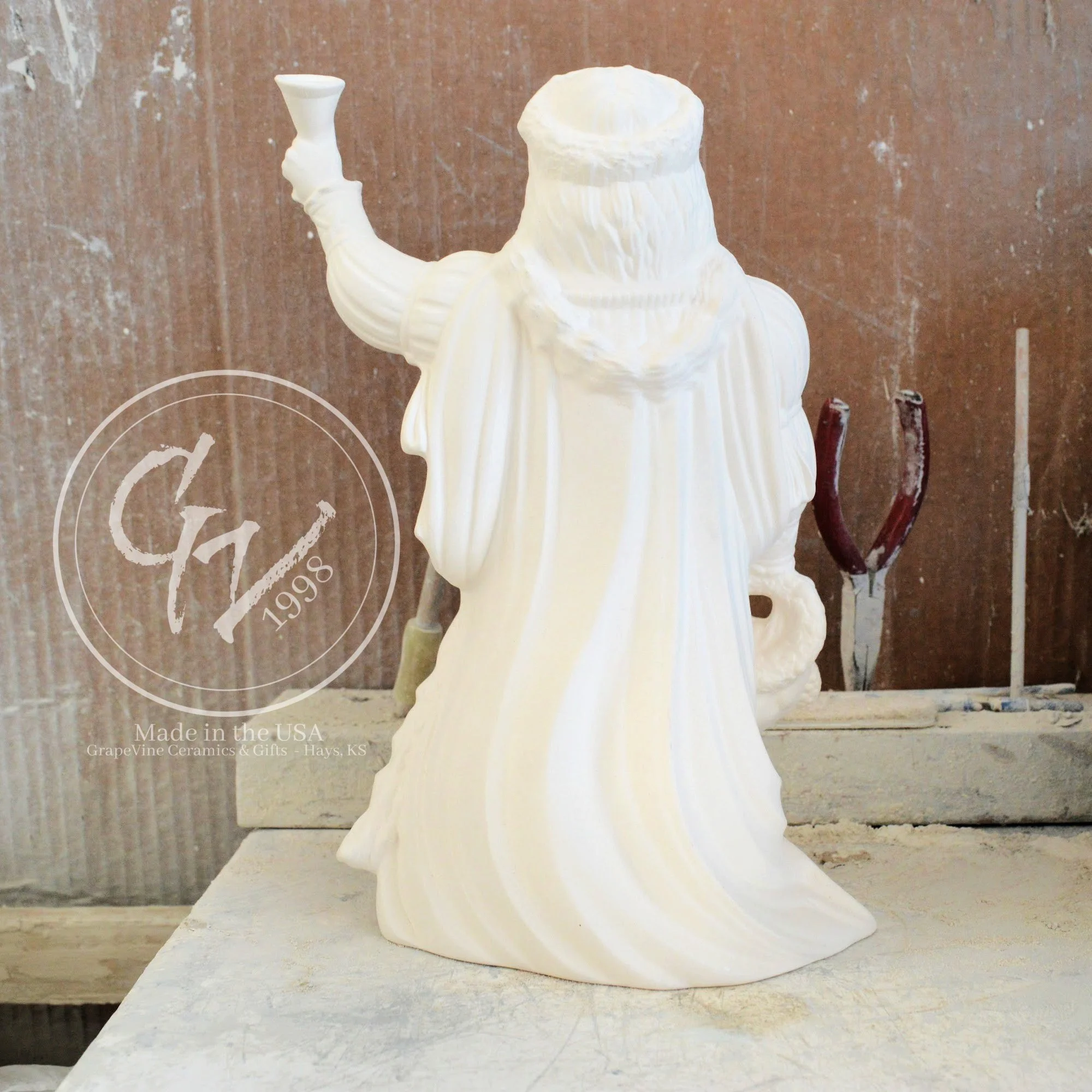 Rear view of the Old English Santa bisque showing the flowing textures of the traditional hooded cloak.