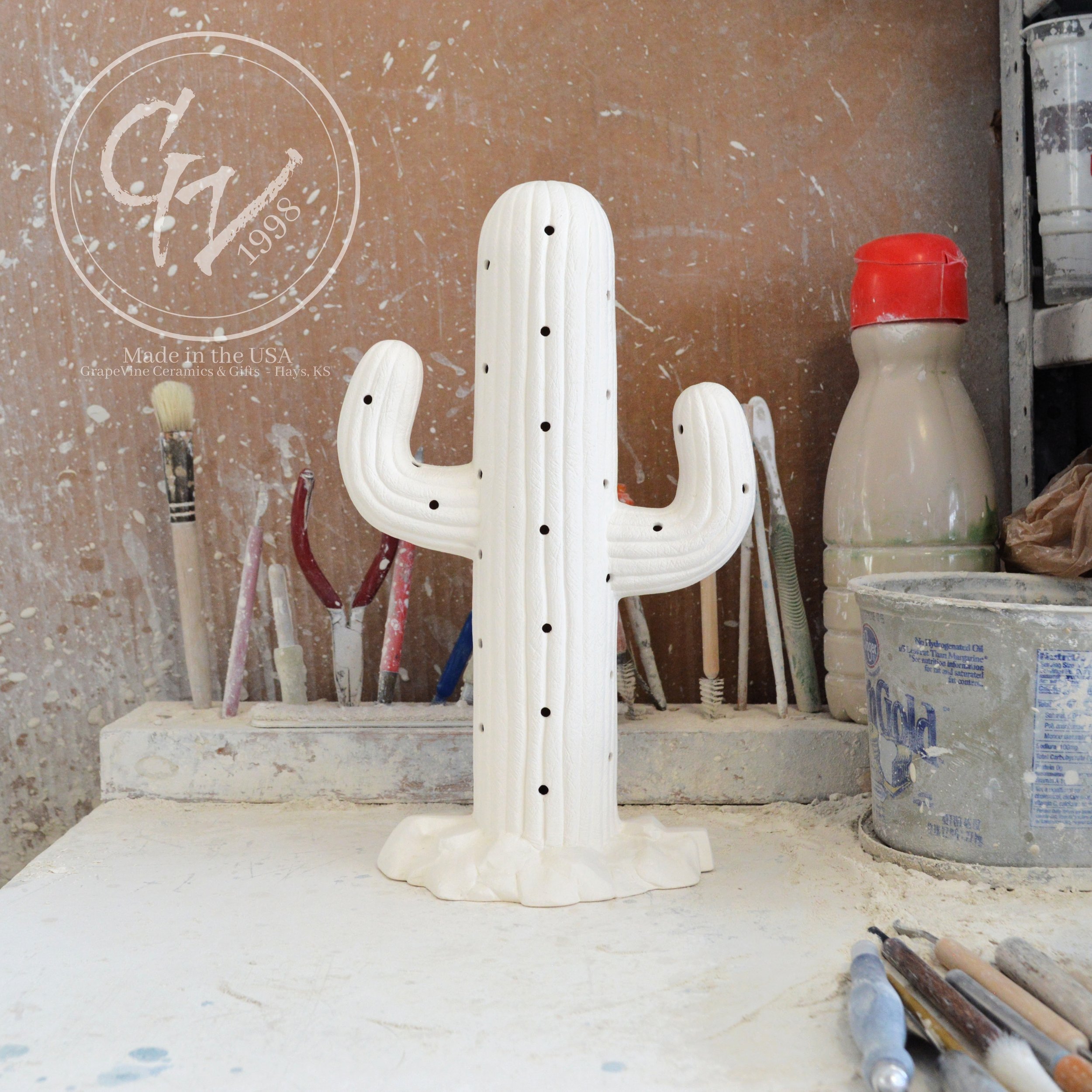 Unpainted white ceramic bisque Saguaro Cactus figurine with holes for Christmas lights, 11 inches tall.
