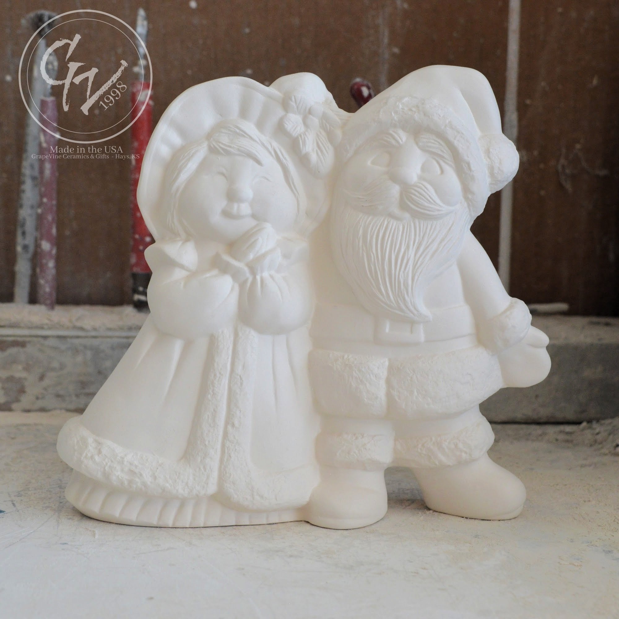 Unfired white ceramic bisque Mr. and Mrs. Santa Claus figurines, 9 inches tall, ready to paint for Christmas DIY crafts.