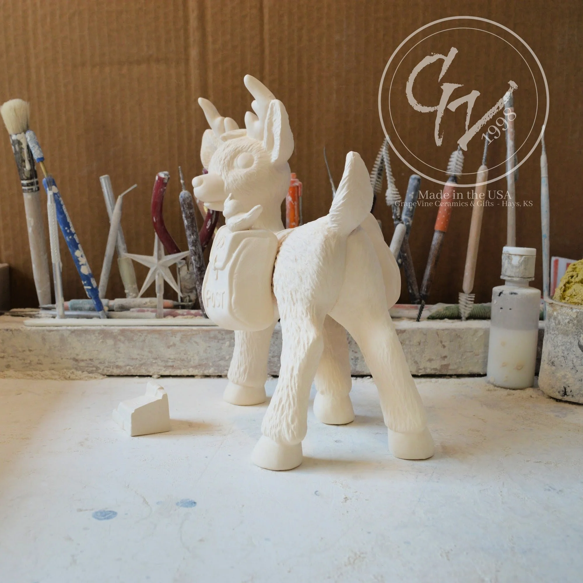 Side view of ready‑to‑paint reindeer carrying holiday mailbag