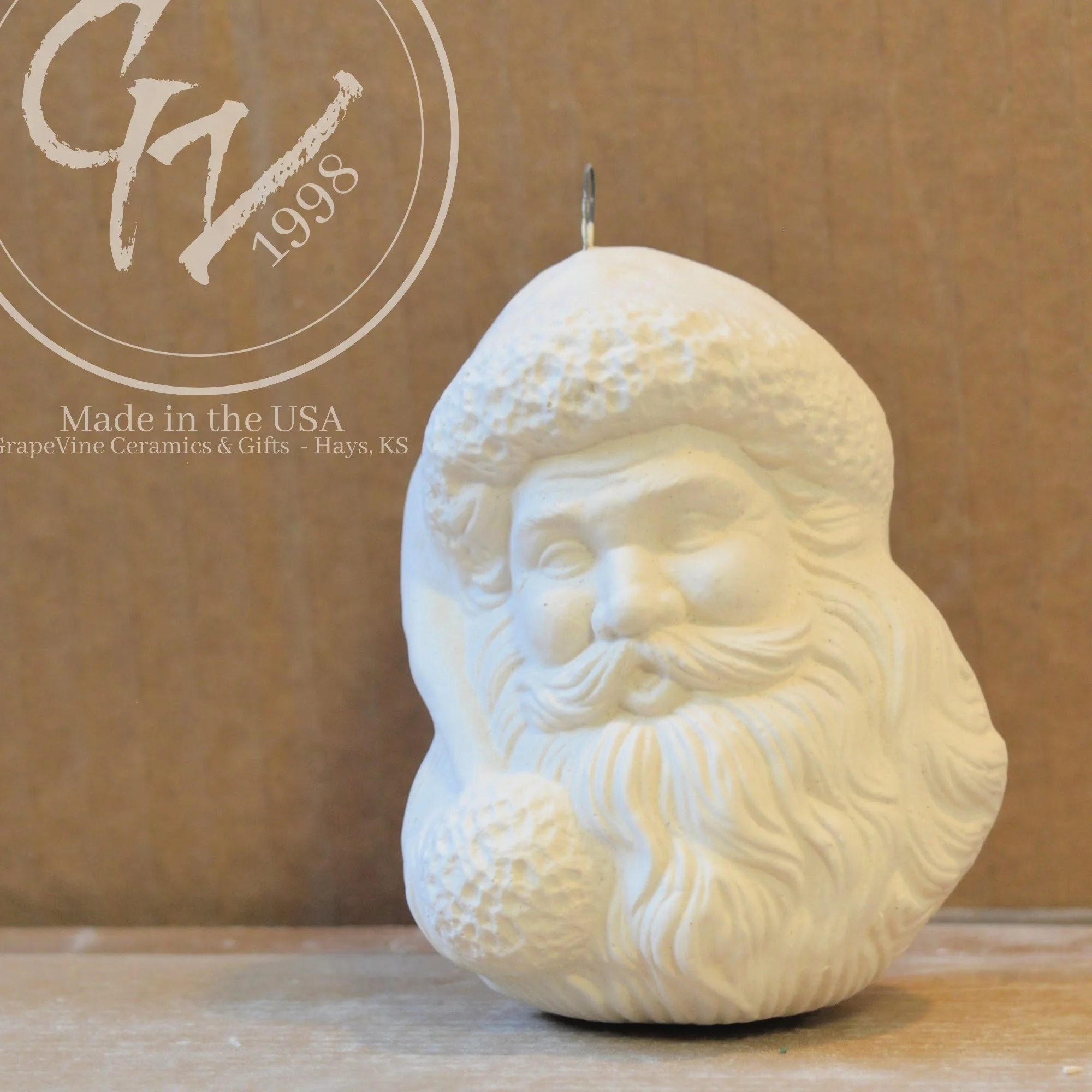 Close up view Hand-poured Santa Head ceramic ornament ready to paint