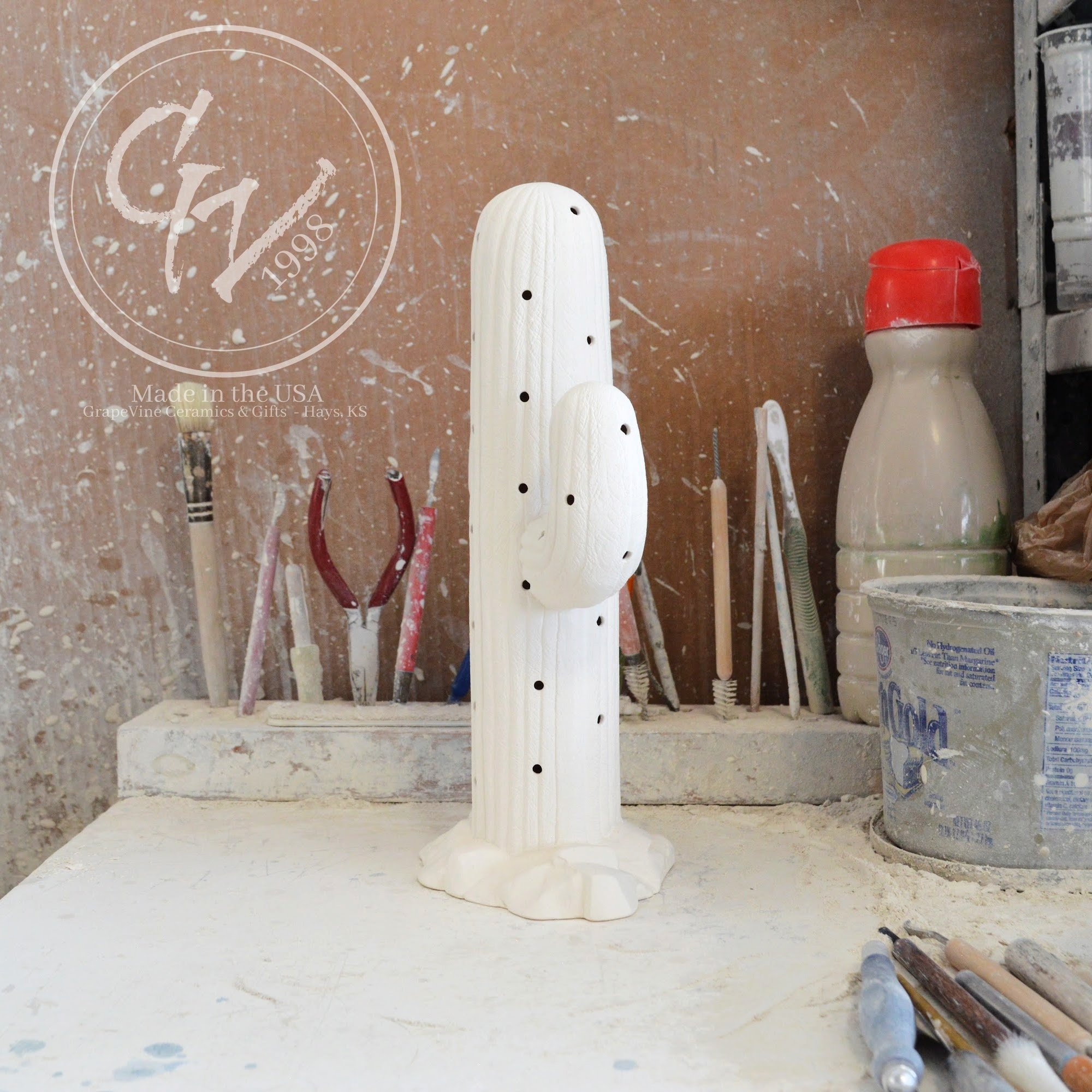 Side profile Unpainted white ceramic bisque Saguaro Cactus figurine with holes for Christmas lights, 11 inches tall.