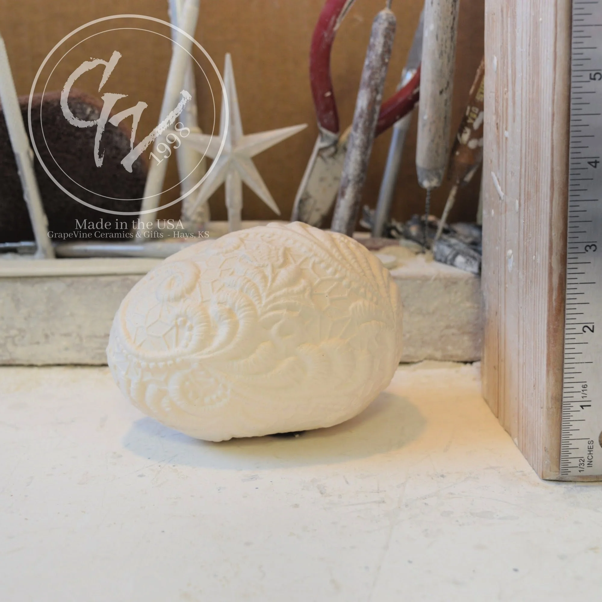 Resting lace duck egg ceramic bisque shown for size comparison and seasonal decorating