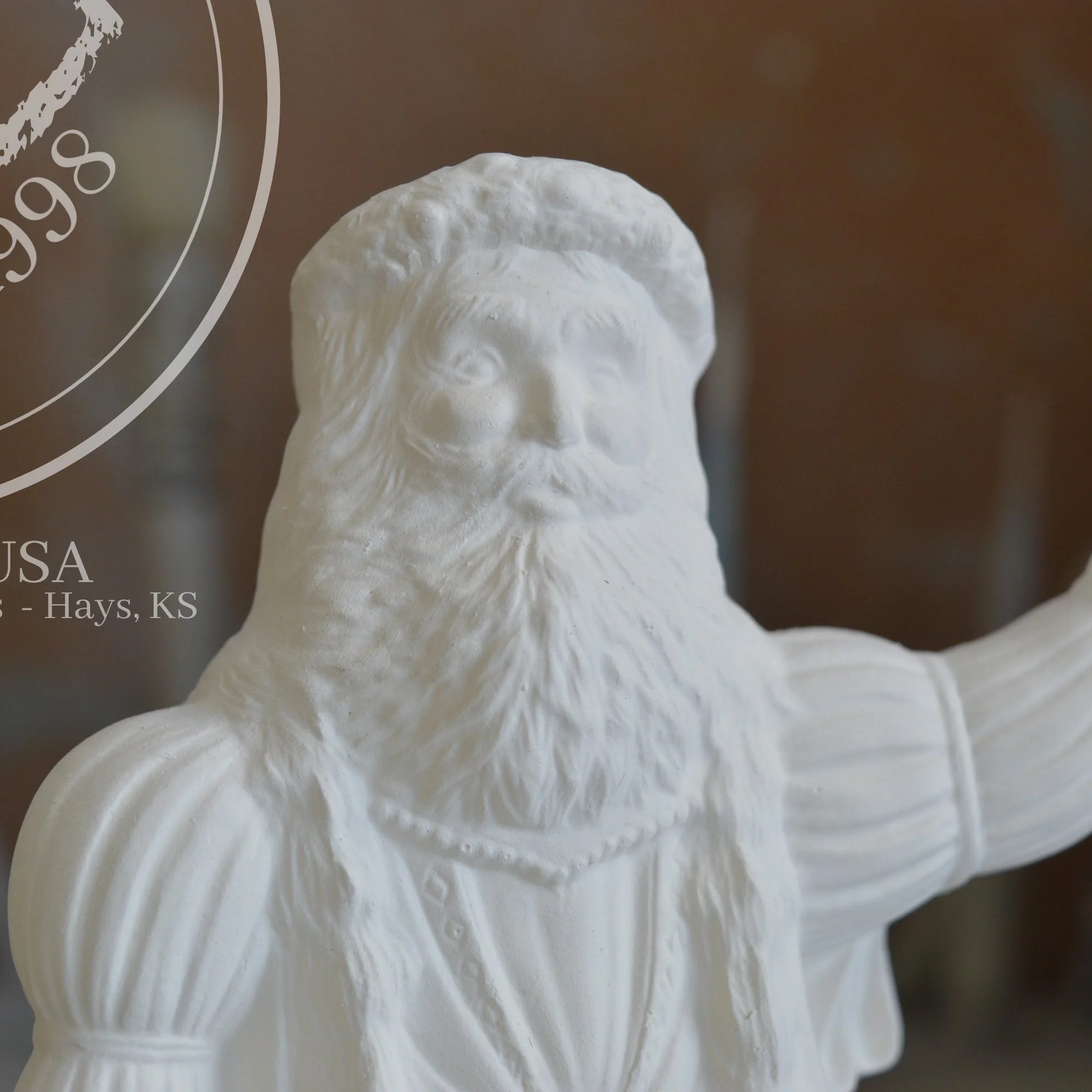 Macro view of the intricate fur texture and facial features on a ready-to-paint Father Christmas bisque.