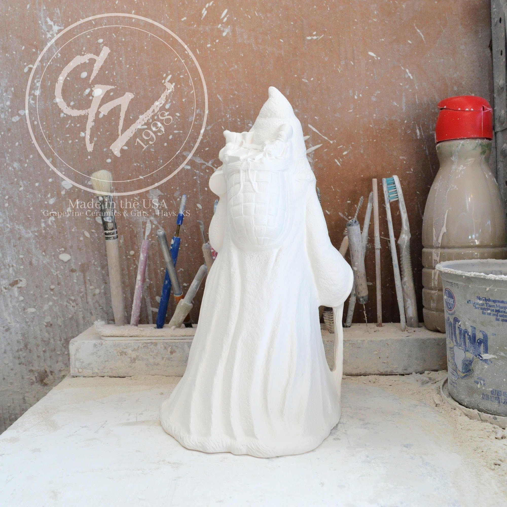 Rear profile of the rare French Santa bisque showing its unique slim silhouette and flowing robe.