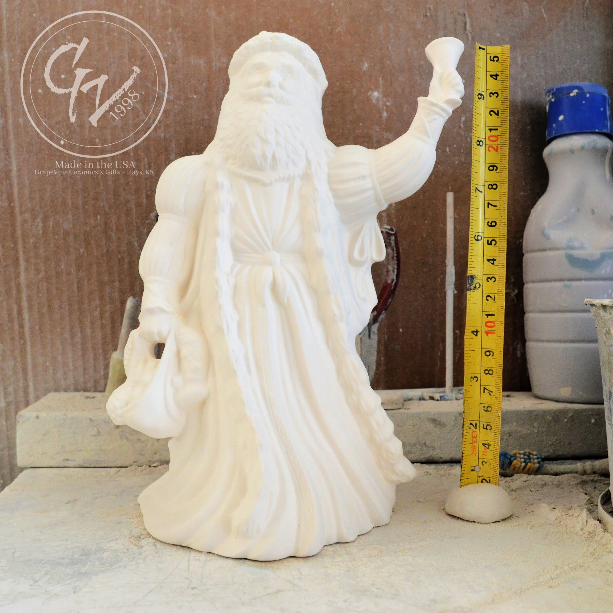 10-inch unpainted Old English Santa ceramic bisque figurine with hooded robe and staff.