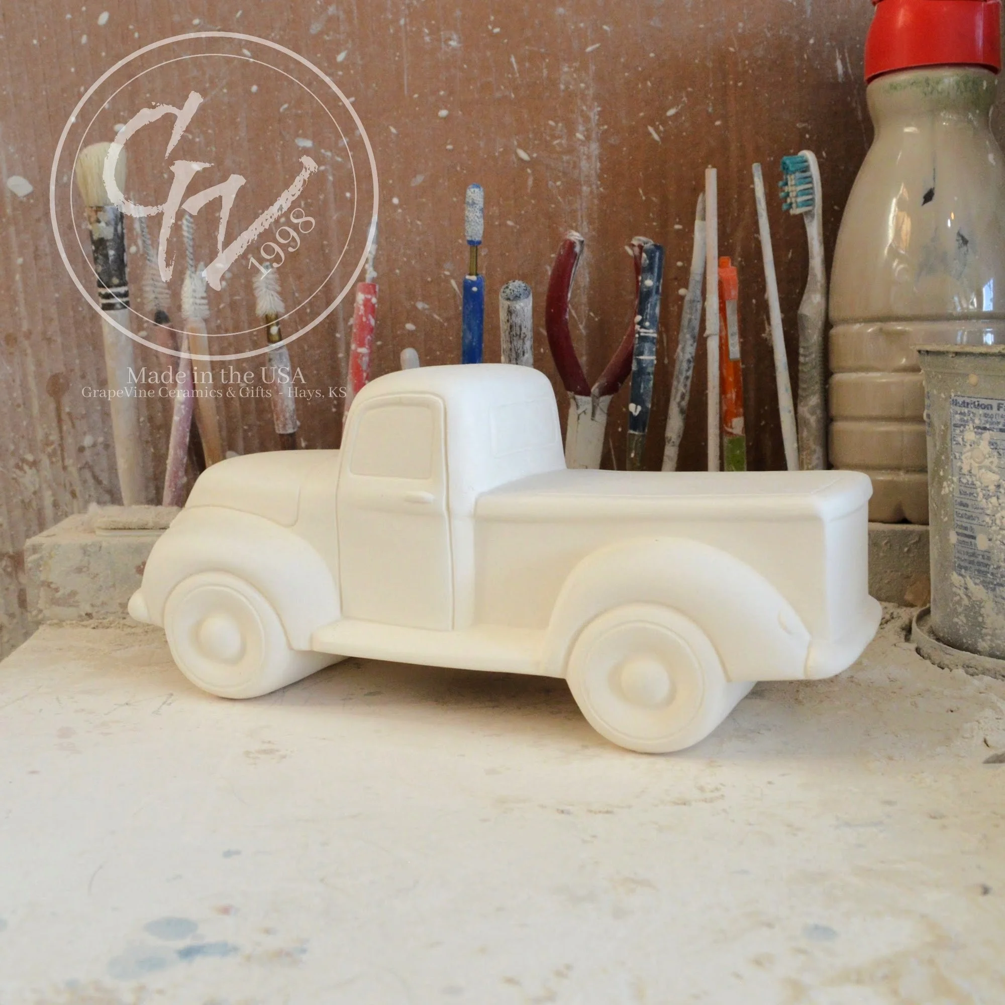 Unpainted white ceramic pickup truck bisque, side view, ready for DIY painting.