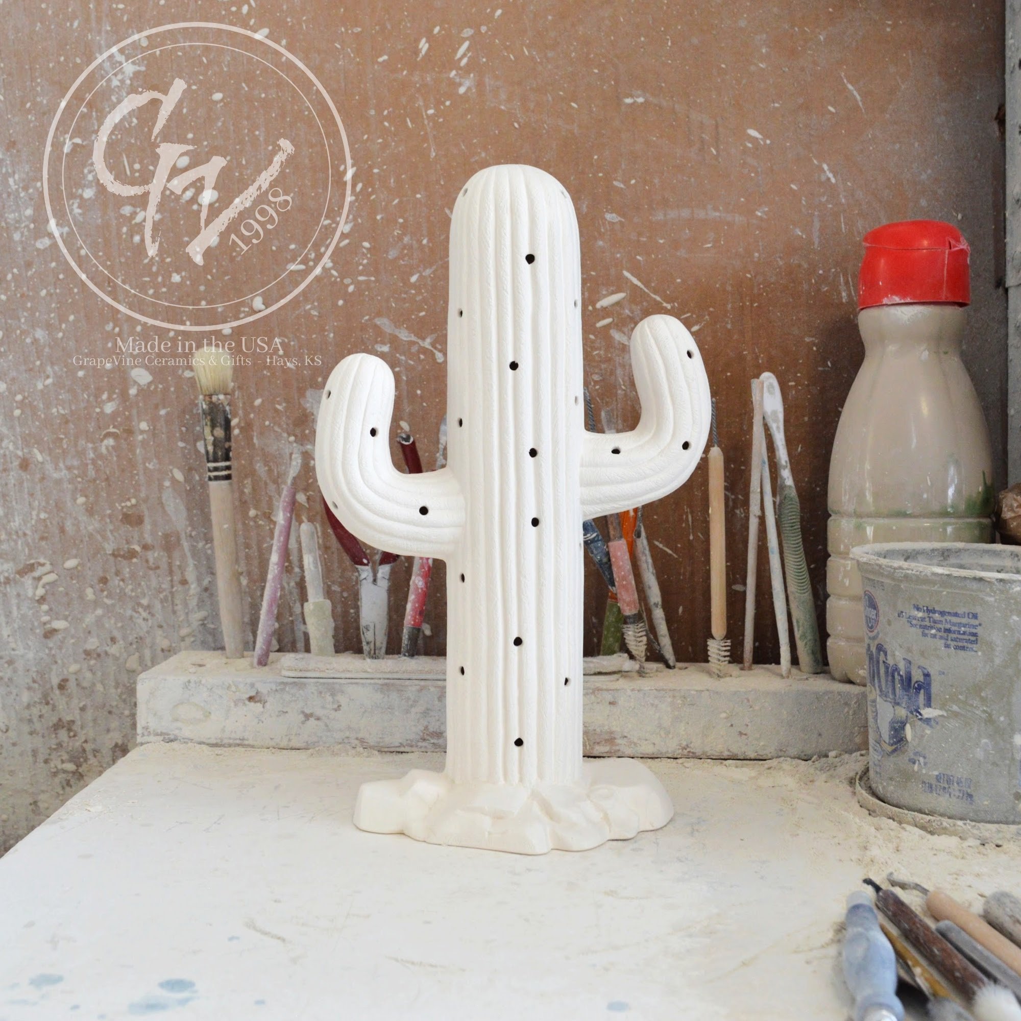 Unpainted white ceramic bisque Saguaro Cactus figurine with holes for Christmas lights, 11 inches tall.