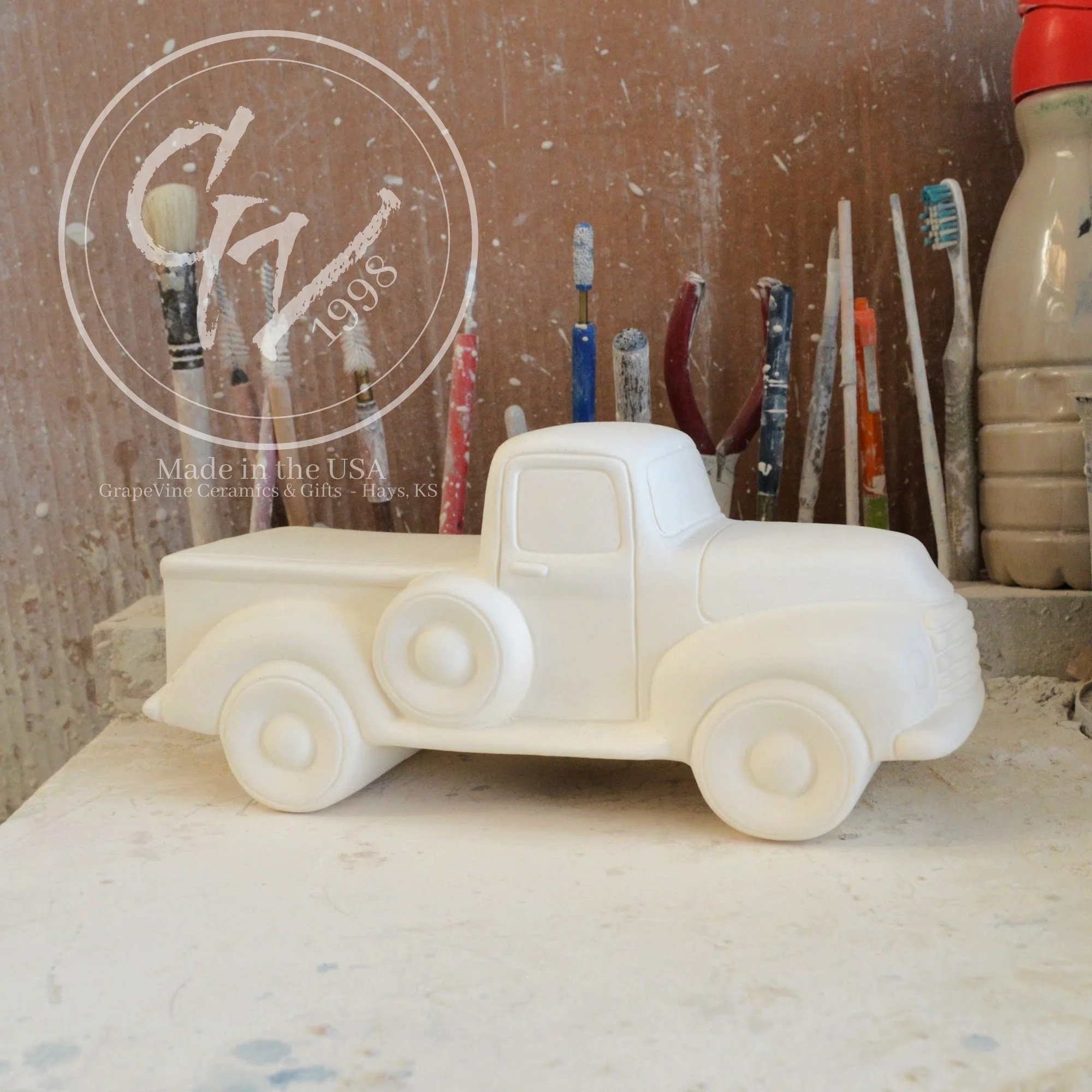 Unpainted white ceramic pickup truck bisque, side view, ready for DIY painting.
