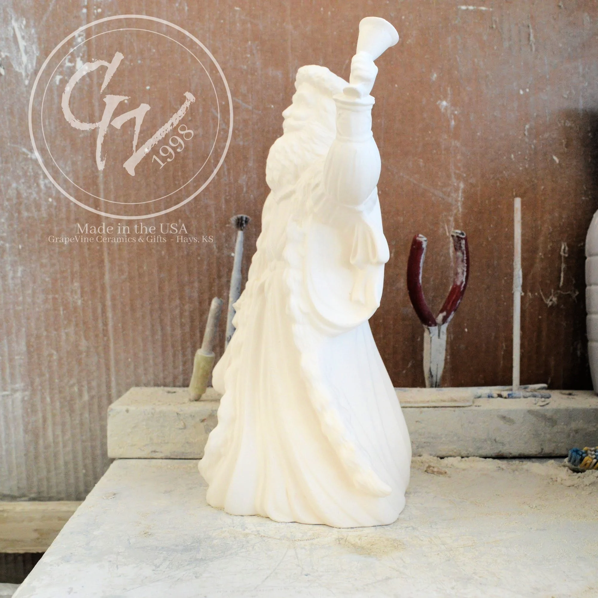 Side view of the Old English Santa bisque showing the flowing textures of the traditional hooded cloak.