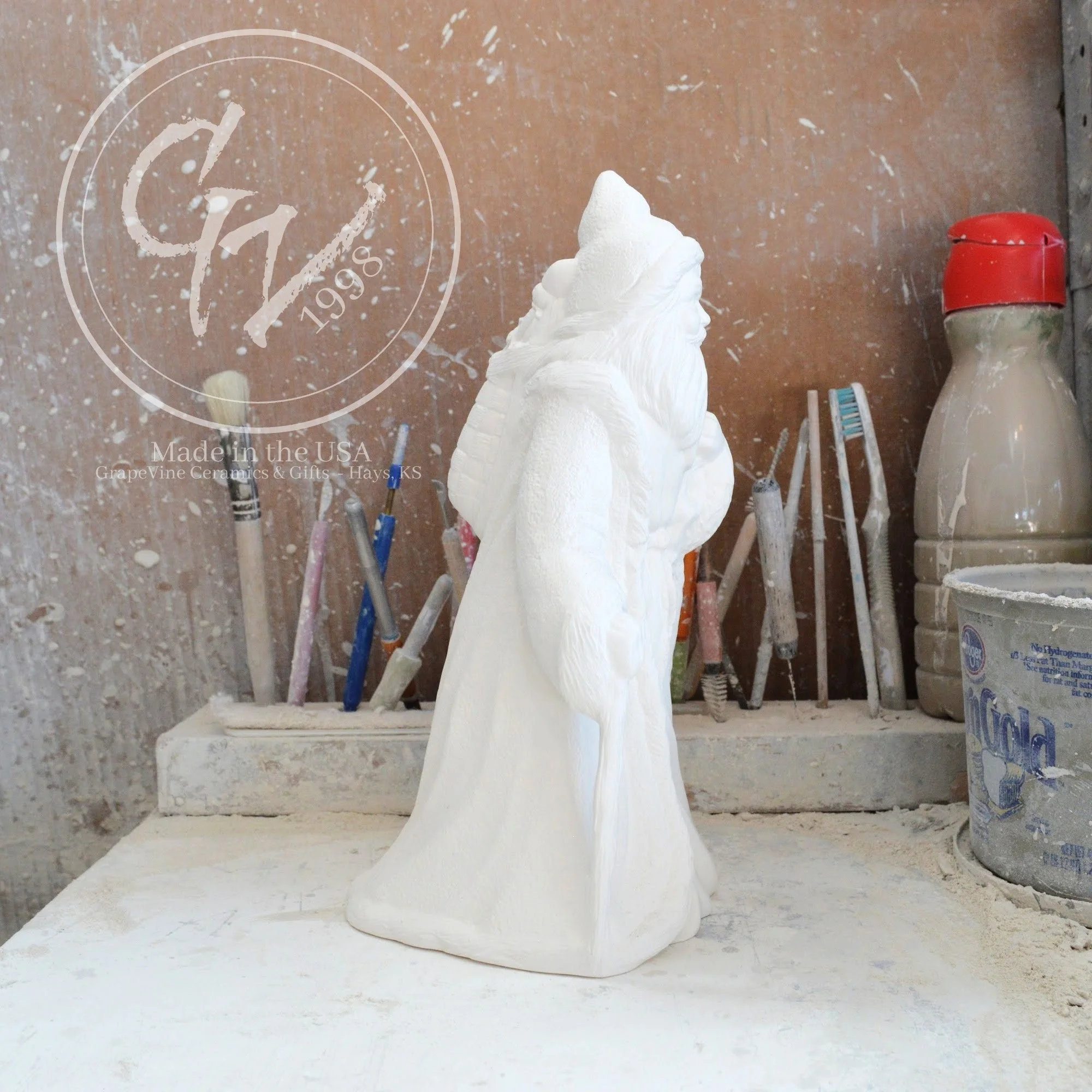 Elegant side profile of the rare French Santa bisque showing its unique slim silhouette and flowing robe.