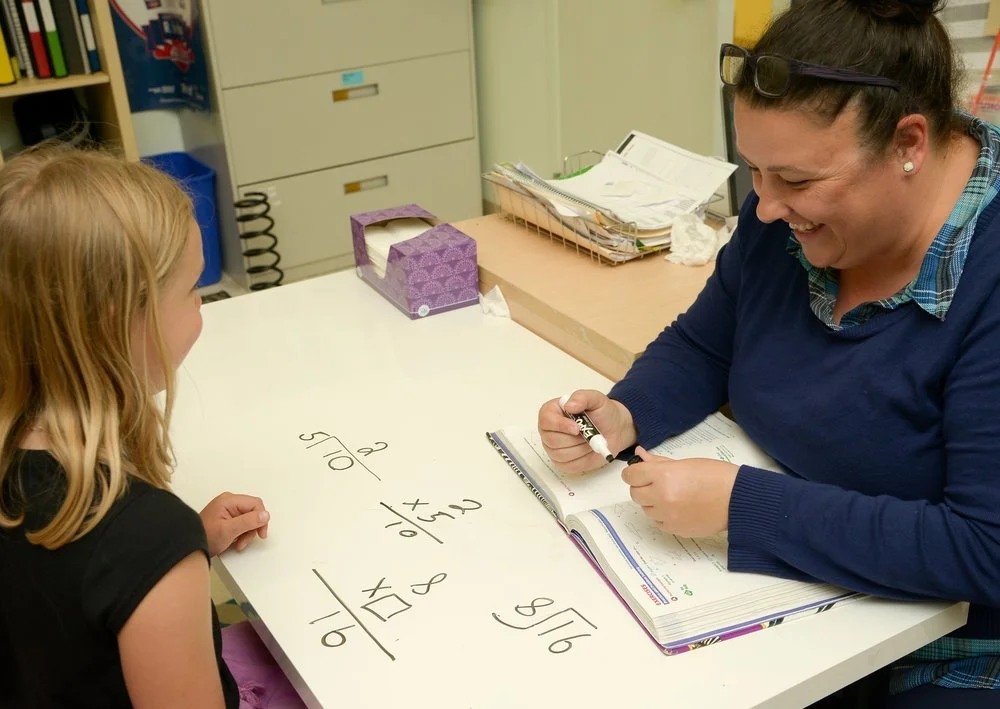 Elementary Clark School students learning math with teacher.