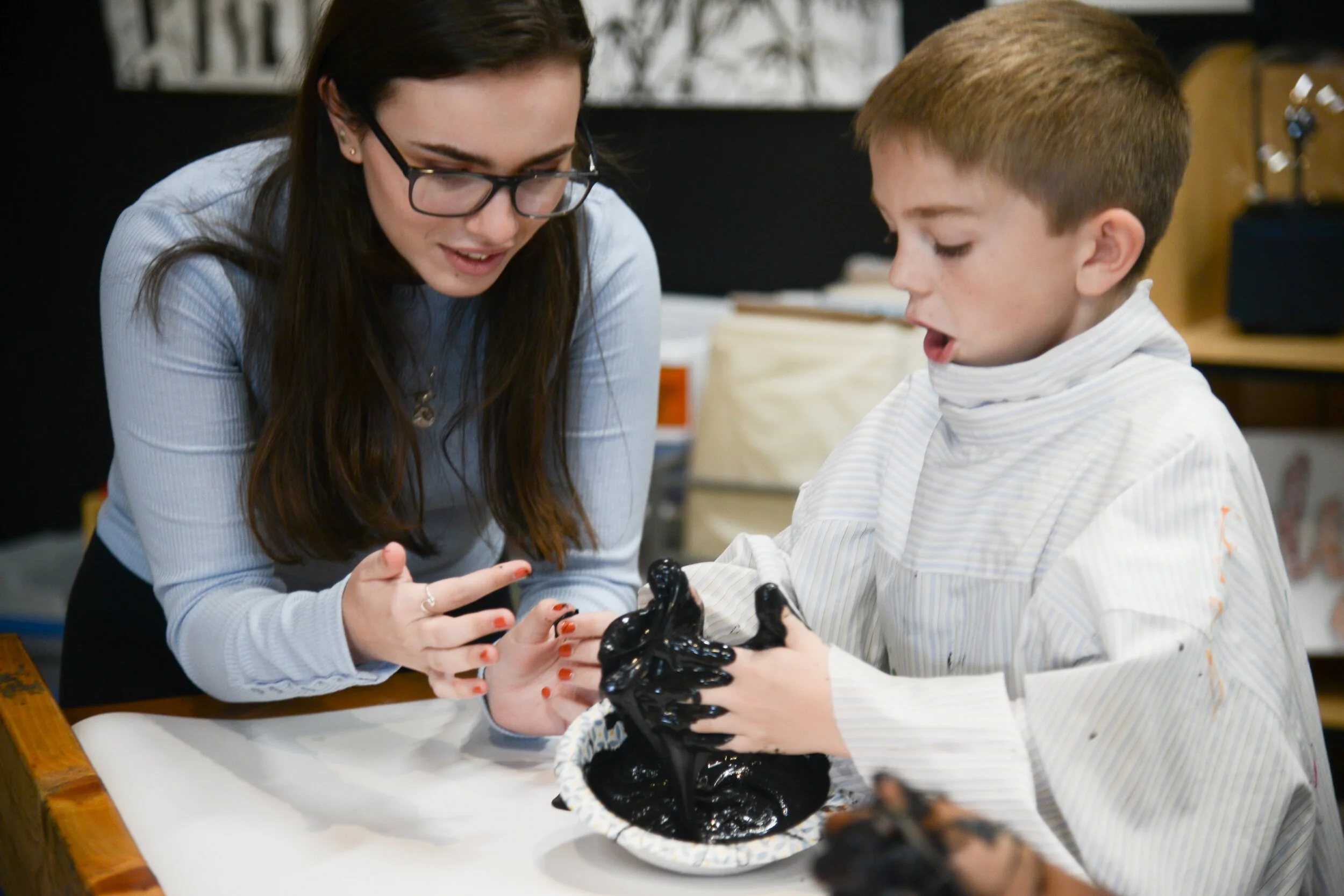 A teacher and student enjoy a science activity at Clark School