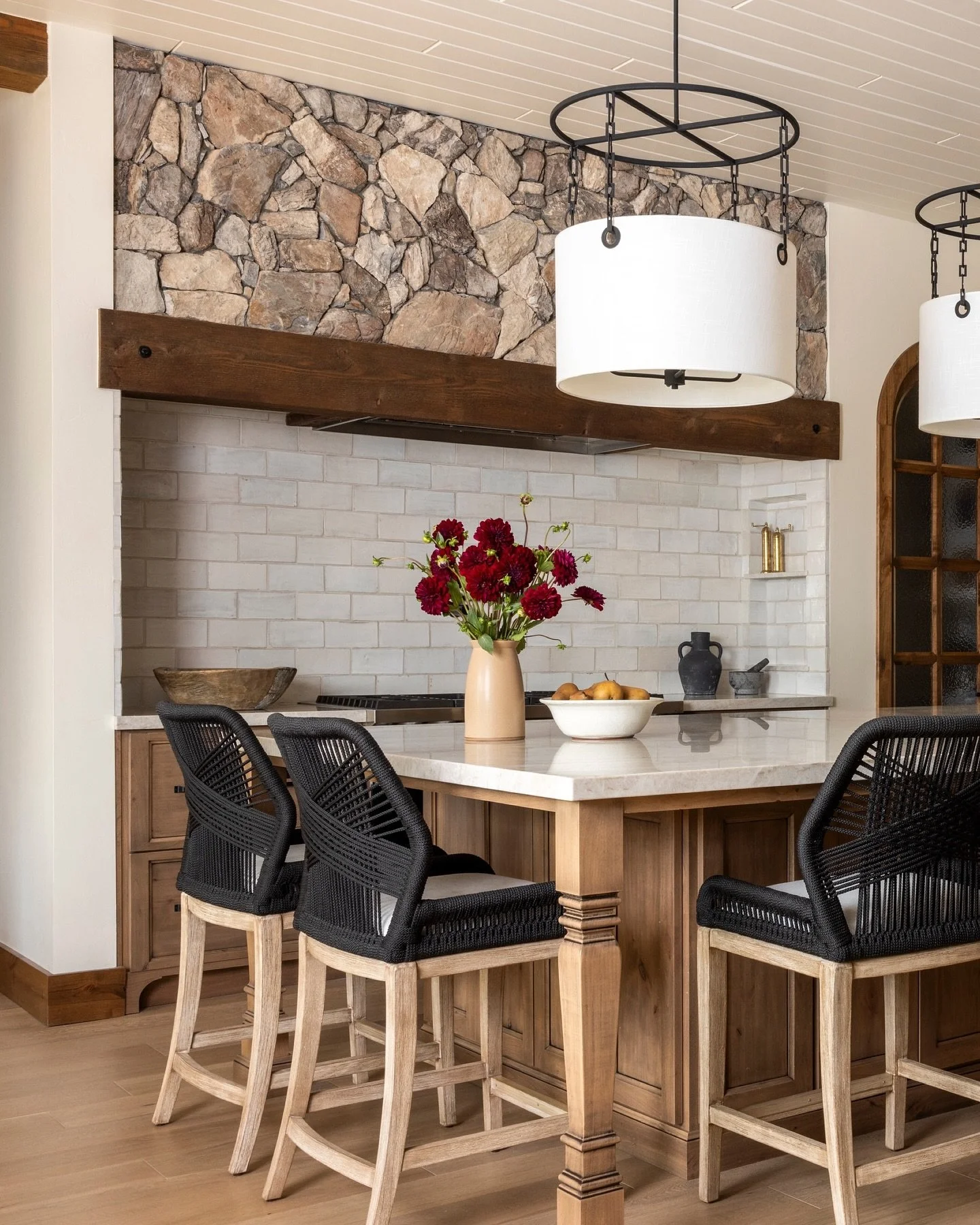 In our Pine Canyon home, warm wood cabinetry contrasts softly with cream tones and natural stone. The custom hood brings the outdoors in, creating a serene forest retreat made for quiet weekends and fresh mountain air. ⁠#LygiaHarkinsInteriors⁠ ⁠
⁠
⁠
