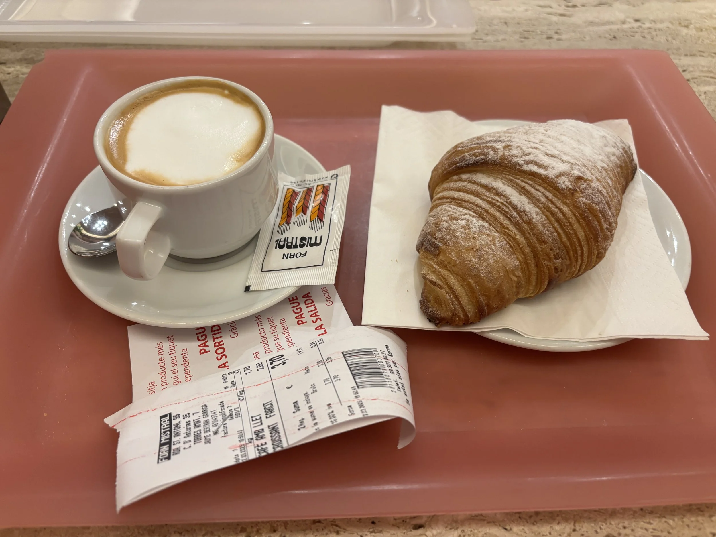 Cappuccino and chocolate croissant from Forn Mistral Cafeteria