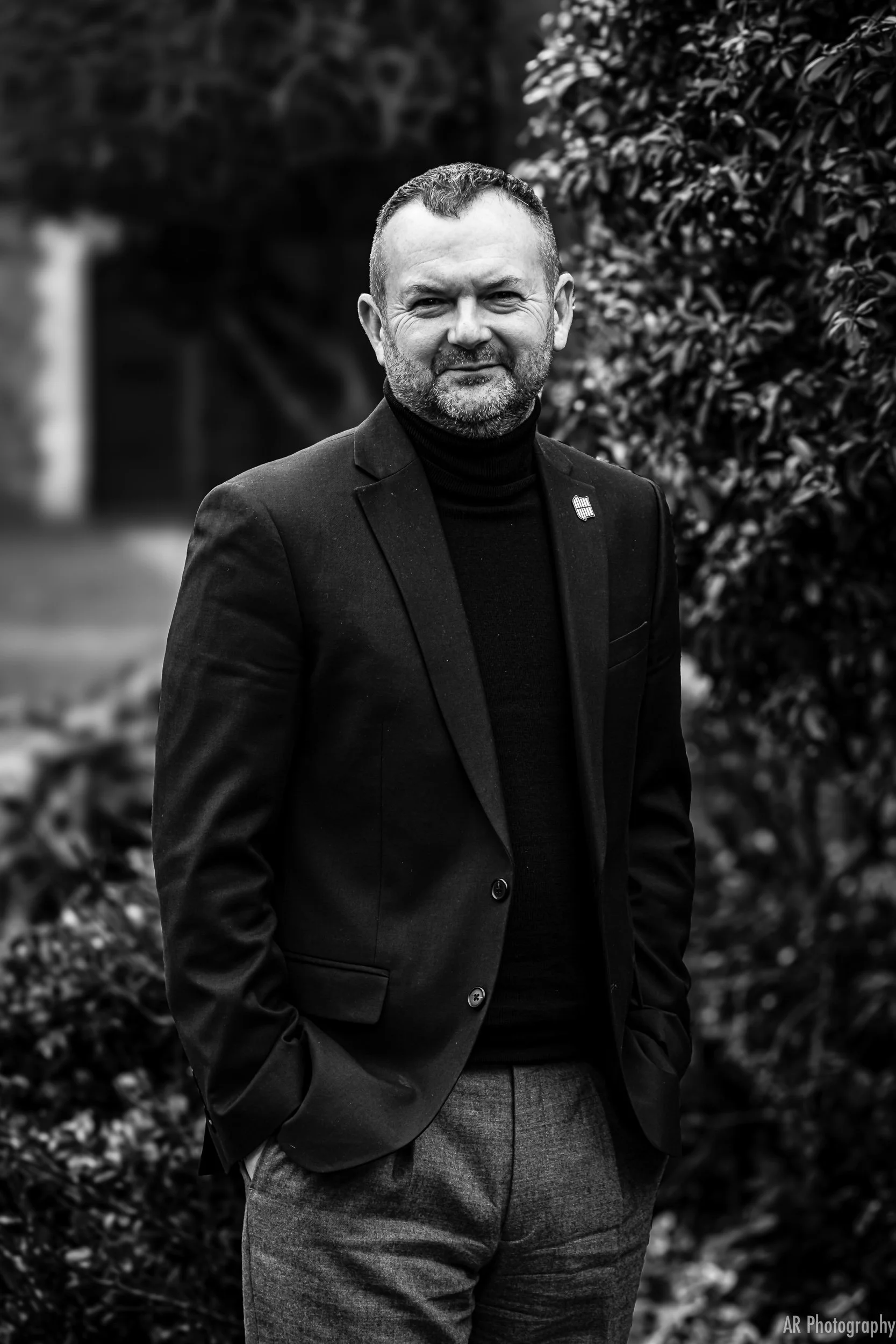 black and white portrait of the director of french furniture company roset uk standing outside his office