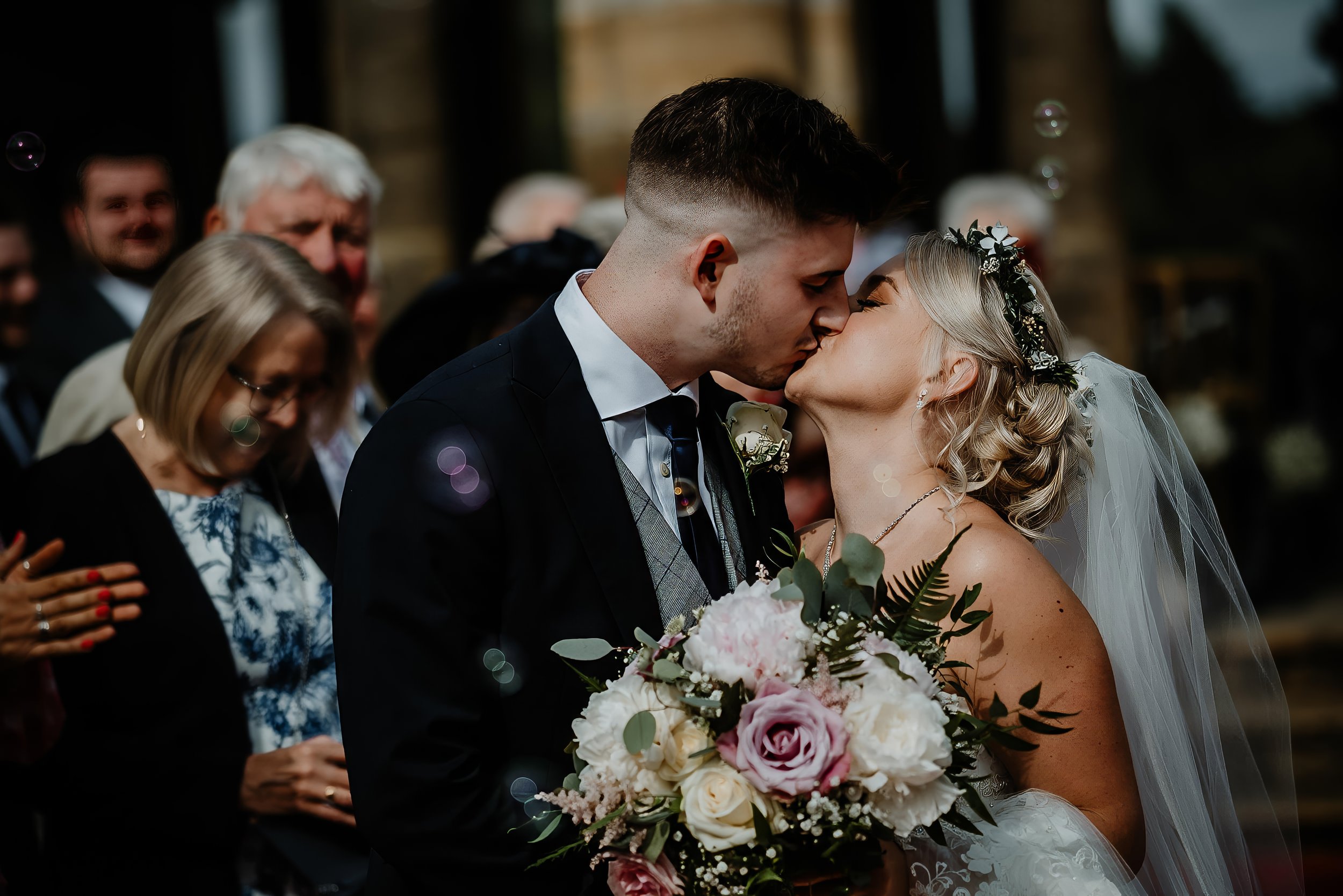 a wedding couple kiss after getting married at hever castle kent