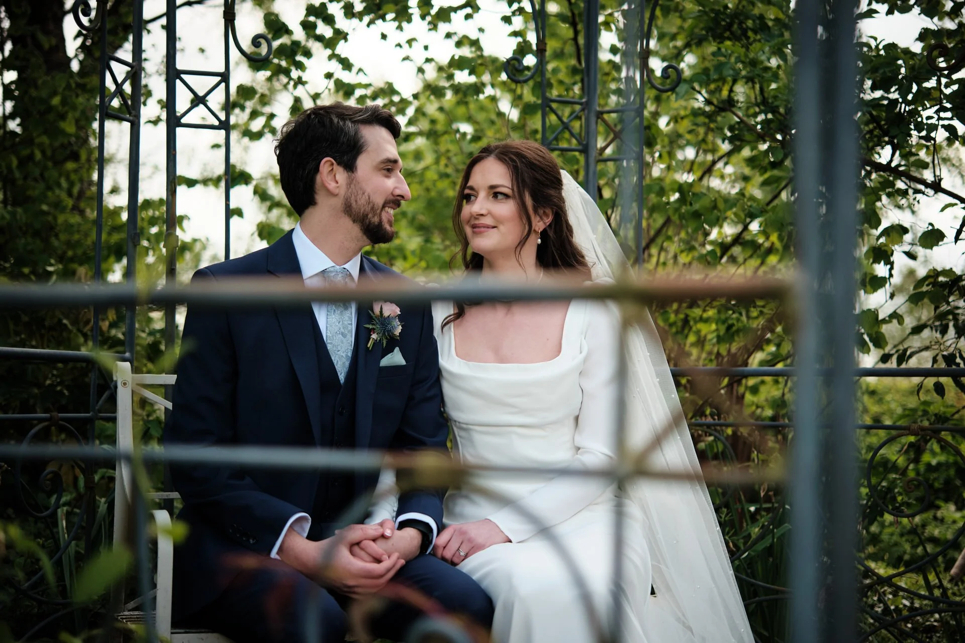 a wedding couple sit outside in the garden of south farm royston