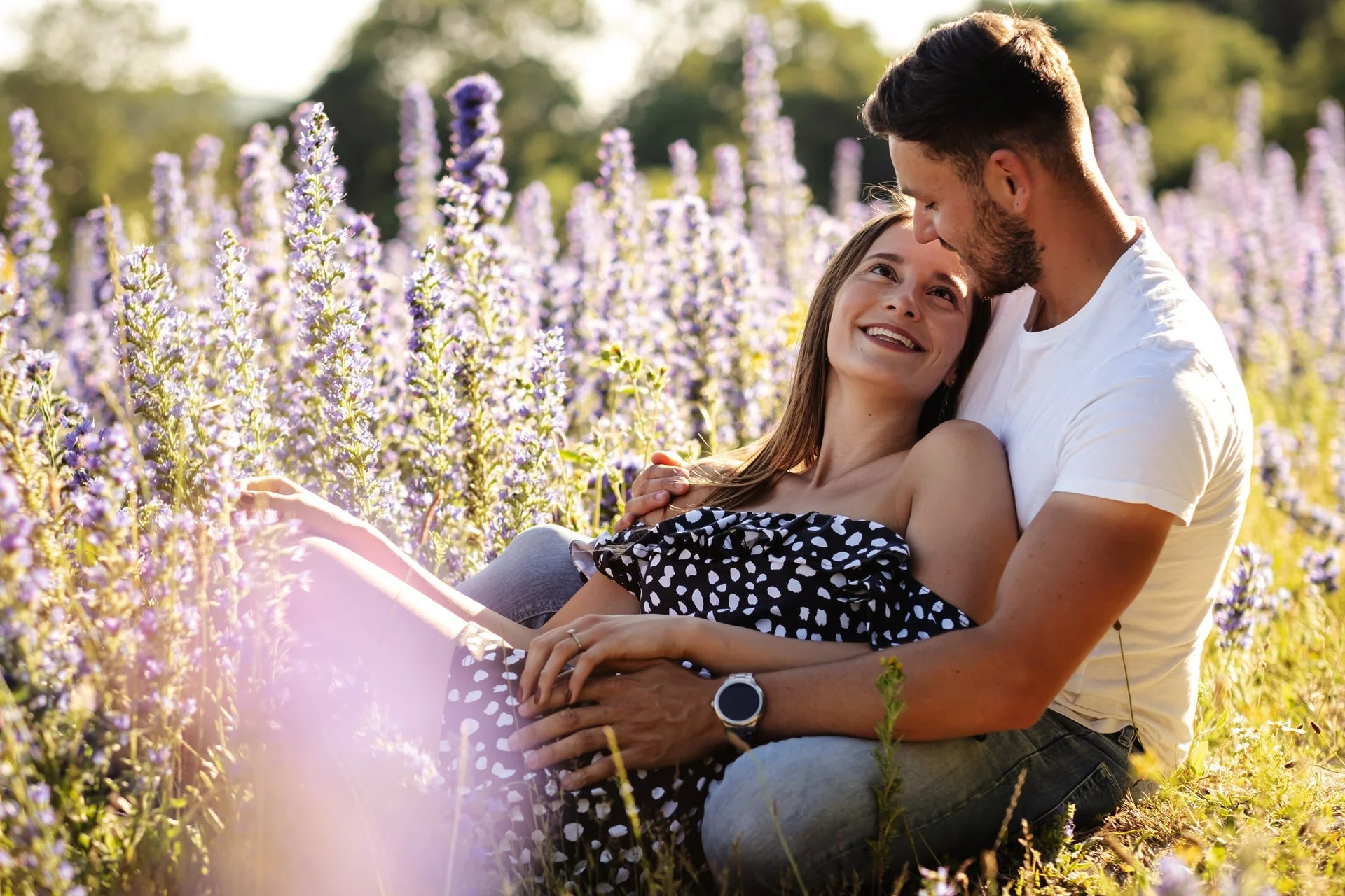 a couple relax in the sunshine for their engagement shoot in Rochester kent