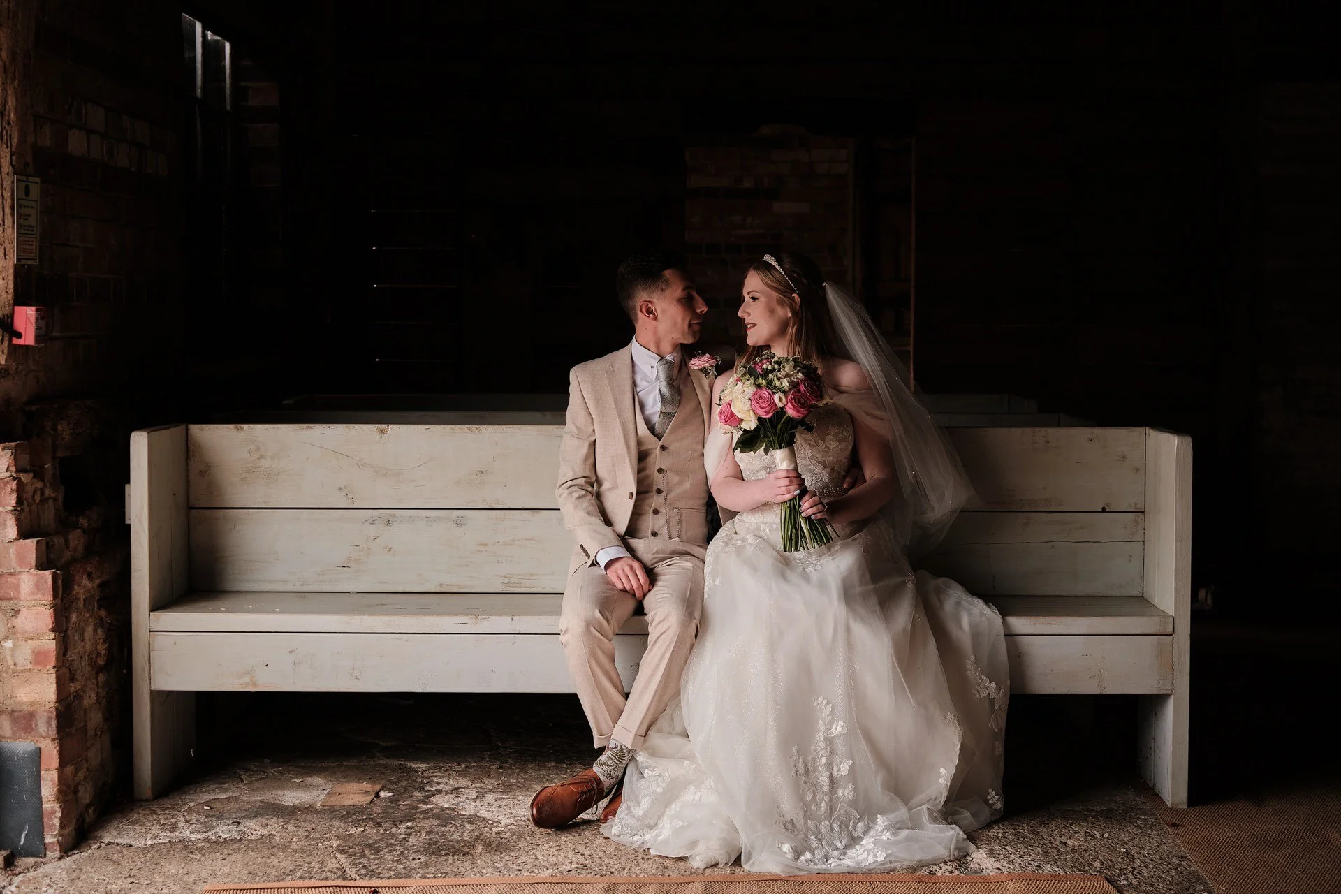 a wedding couple share a moment at milling barn wedding venue throcking
