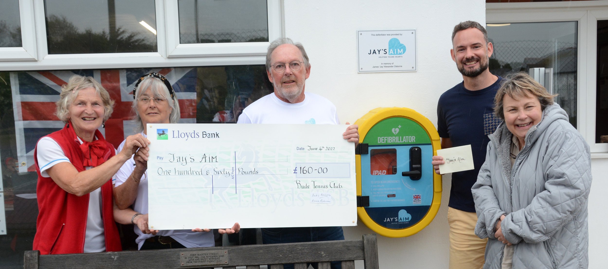 Presenting a cheque to Jay's Aim and the installation of the defibrillator
