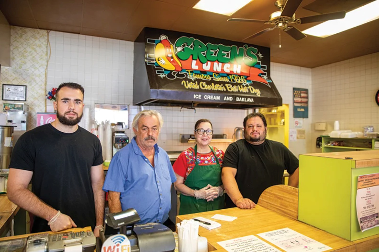  Zack Cheek, Pete Sikiotis, Joane Pastrana, and Pete’s son, Nick, behind the counter. Photo by Peter Taylor,  Charlotte Magazine.  