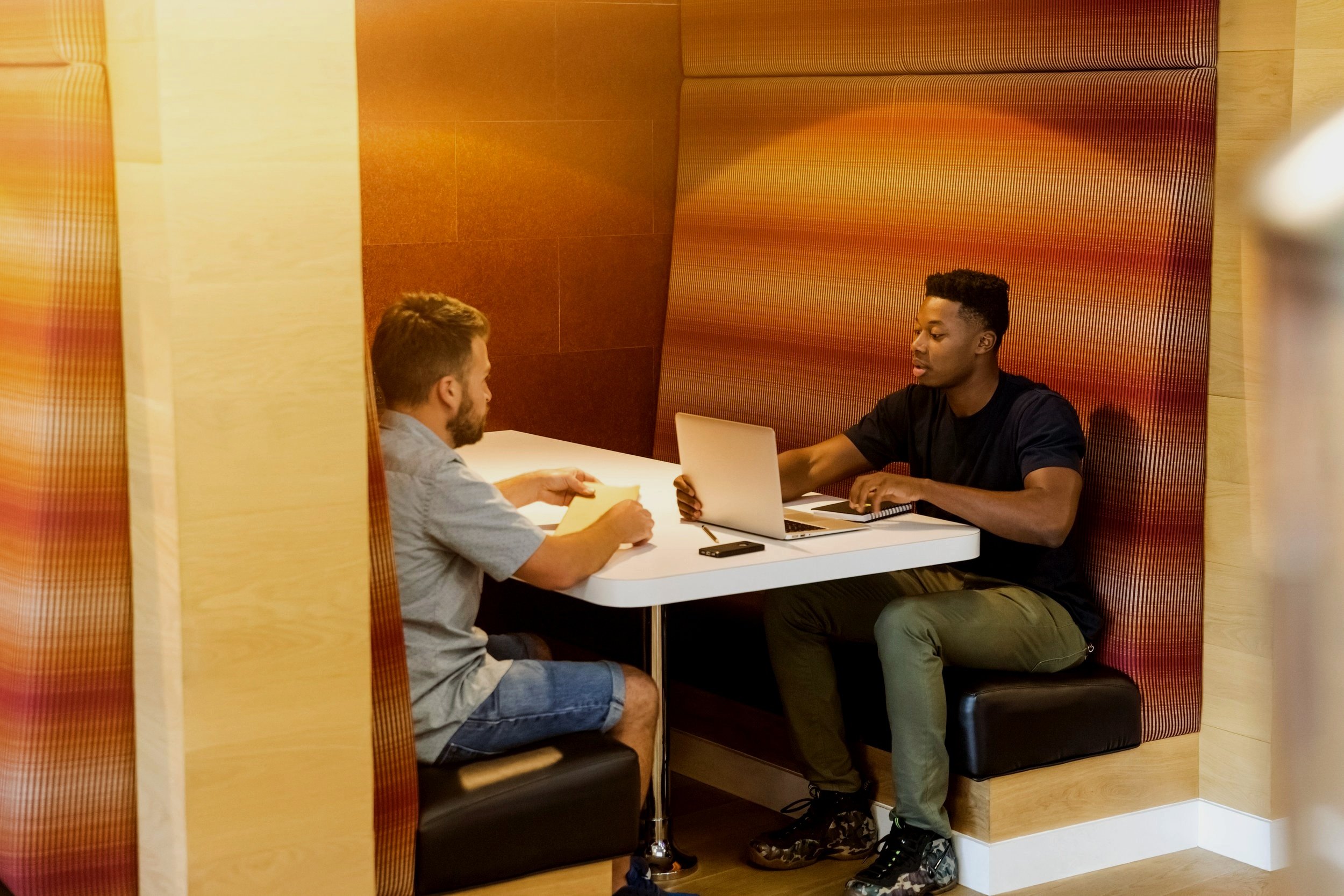 adults meeting at the library in a booth