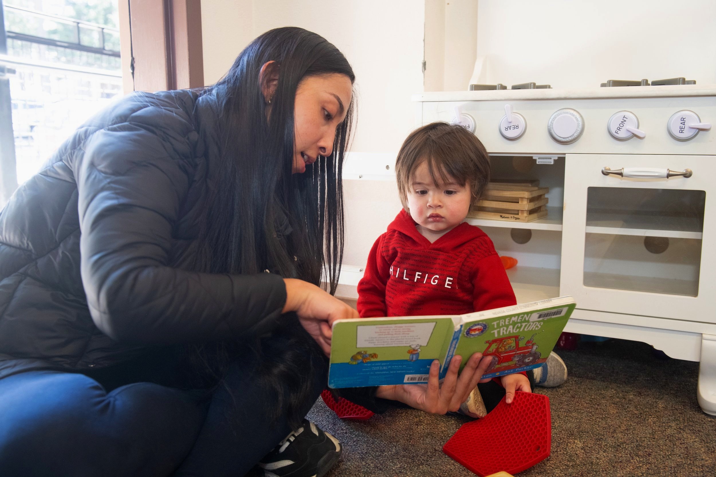 mom reading to child at the library