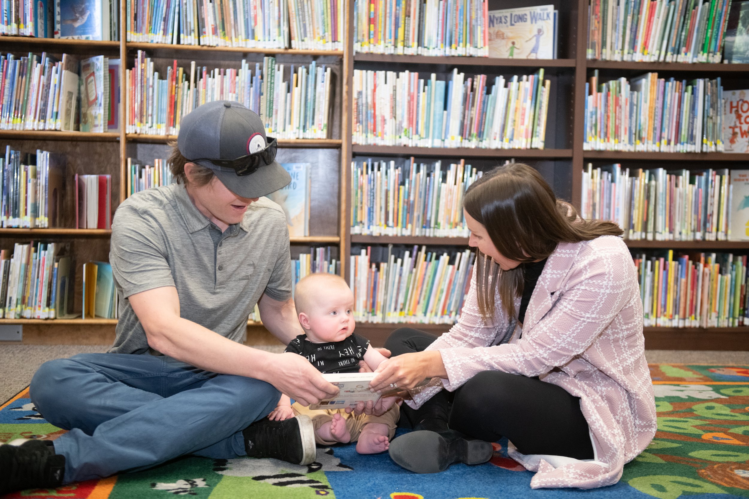 couple sitting down reading to child