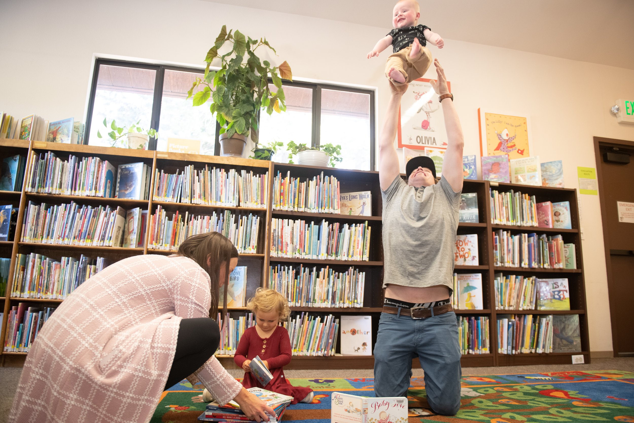 two adults and two children in the library